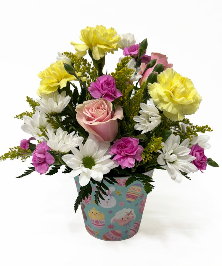 EASTER PAIL - Celebrate Easter with this beautiful arrangement of roses, carnations, daisies, spring filler and more in soft pastel hues in a festive easter pail.