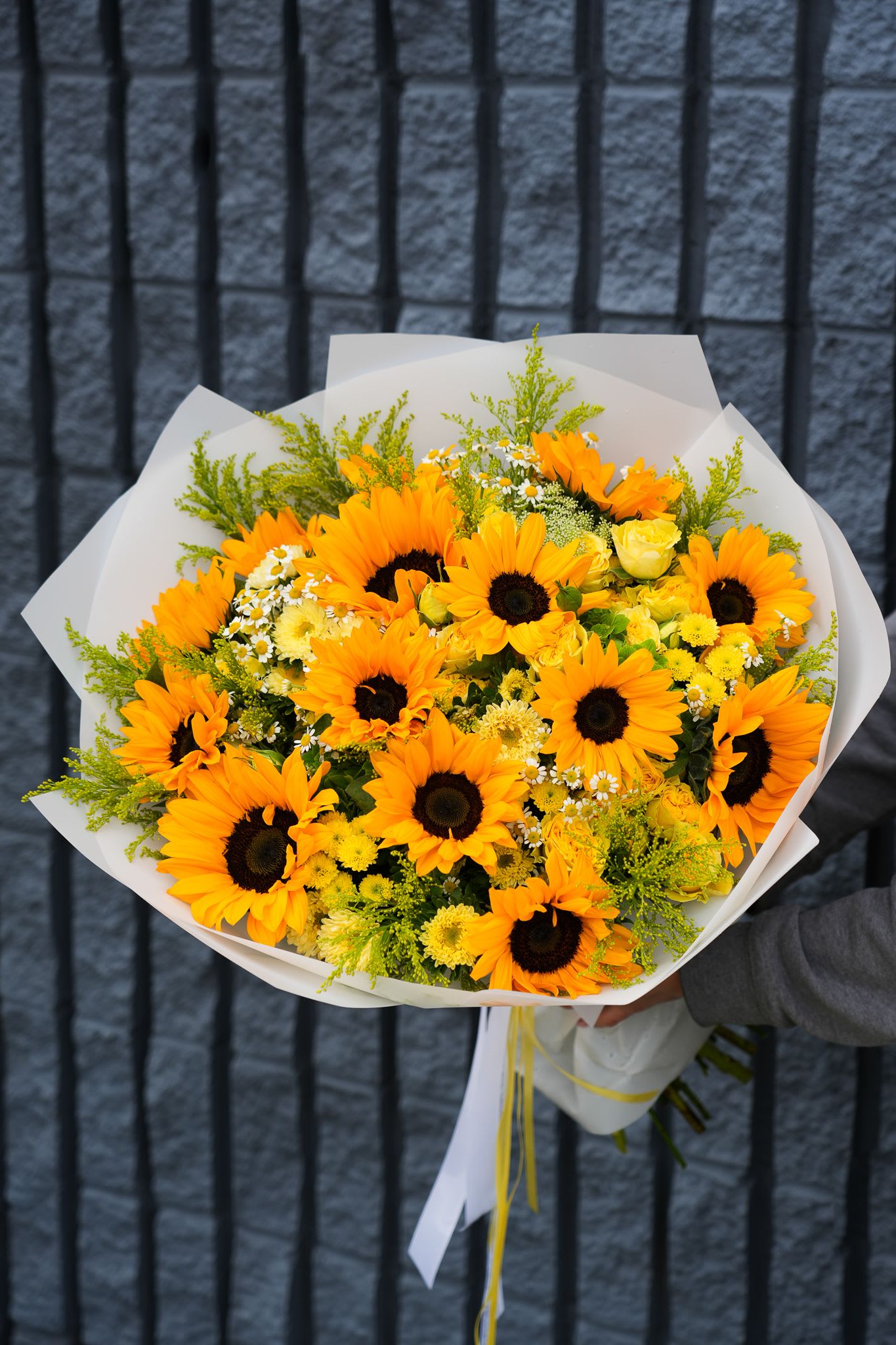 Golden Morning Golden Morning - Let the sunshine in with Golden Morning, a radiant bouquet bursting with joy. Featuring vibrant sunflowers, cheerful yellow roses, delicate chamomile, golden chrysanthemums, and fresh greenery, this arrangement captures the essence of a bright summer day. Wrapped in crisp white paper and tied with elegant ribbons, it’s perfect for birthdays, congratulations, or just to say, “you light up my life.” Same-day delivery available across Los Angeles