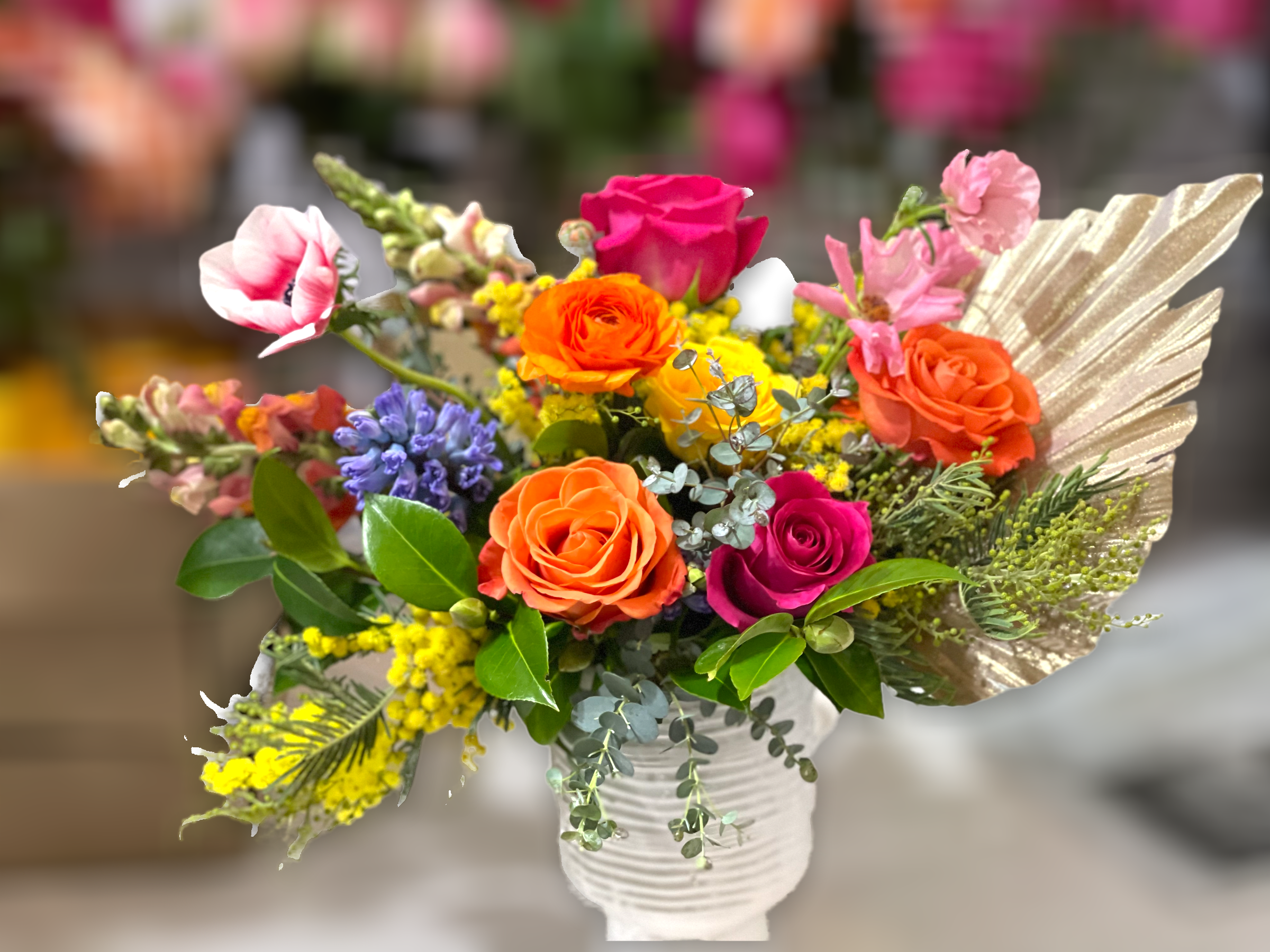 Seville Seville - Fun and feminine, this arrangement is sure to bring excitement to any recipient. Created in a quality textured ceramic vase and made up of colorful roses, anemones, snapdragons, a colorful decorative palm, and sweet fragrant hyacinths (when in season). Perfect flowers for birthdays, "get well soon," new baby, congratulations, romantic gestures, and "Thank you." Also a beautiful wedding palette. Available for delivery in Seattle, Bellevue, Shoreline, and surrounding areas. Available for delivery in all neighborhoods in Seattle including Magnolia, Ballard, Fremont, Downtown, Queen Anne, Crown Hill, U District, West Seattle, International District, Capitol Hill, Pioneer Square, Beacon Hill, Columbia City, Georgetown, etc.