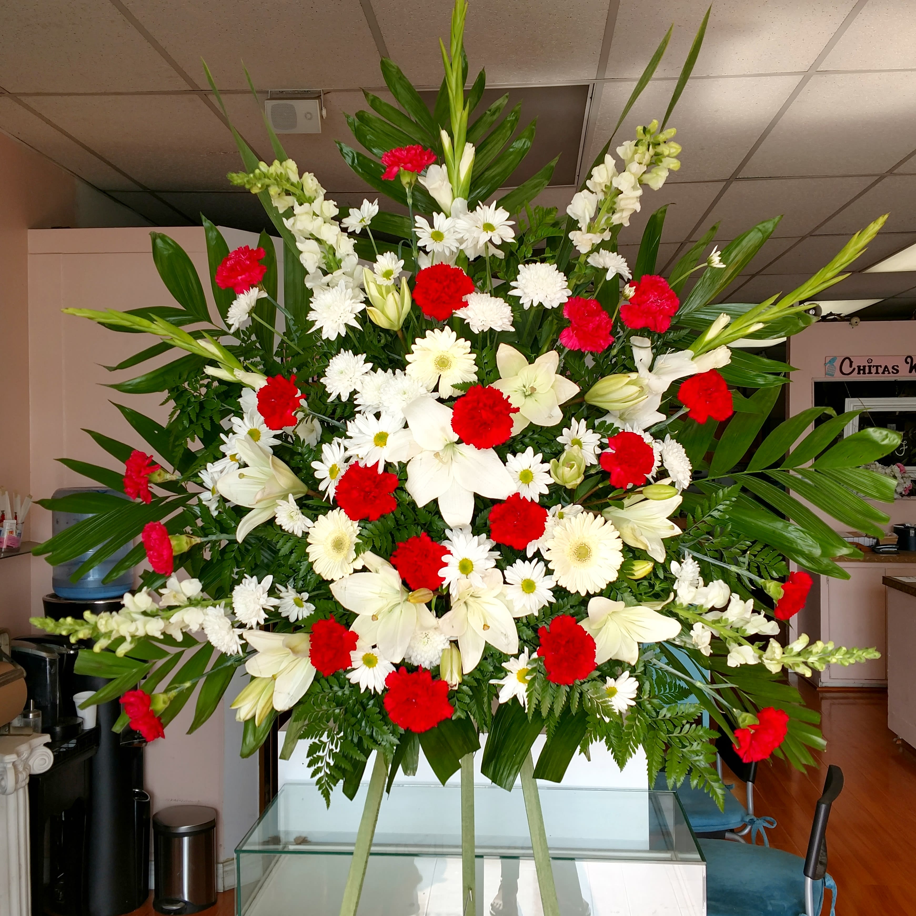 Half Standing Spray Half Standing Spray - This reaches approximately 7ft tall and is a half size casket spray. Can come in any colors and will have lilies, carnations and several other flowers.