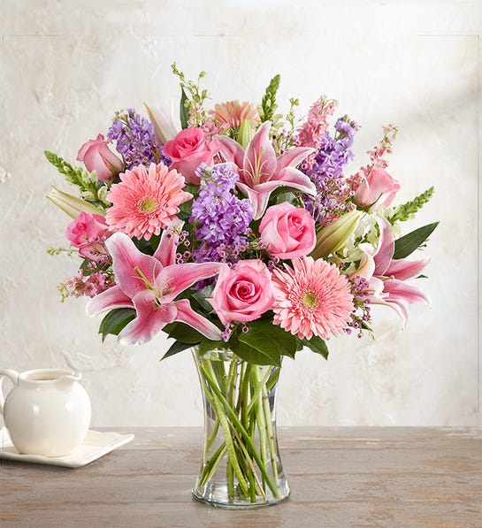 Always On My Mind™ Flower Bouquet - LOCAL ARTISAN  When it comes to letting her know she’s always on your mind, think pink and lavender. We’ve hand-gathered a romantic mix of pink and purple blooms to create a gorgeous, garden-inspired bouquet. Designed by expert florist Breanna Cartwright of Modesto, CA, this beautiful bunch will remain a fond memory for a long time.  All-around arrangement with pink roses, Gerbera daisies, Oriental lilies, and larkspur, white snapdragons, and lavender stock Large measures approximately 23”H x 14”W Artistically designed in a clear glass gathering vase; measures 8”H About Our Local Artisan Design Workshop Each year, we bring together a select group of the most talented florists from across the country to create unique product concepts. Selected designs become part of the Local Artisan Collection and are available exclusively for delivery nationwide.   vases change depending if on stock 