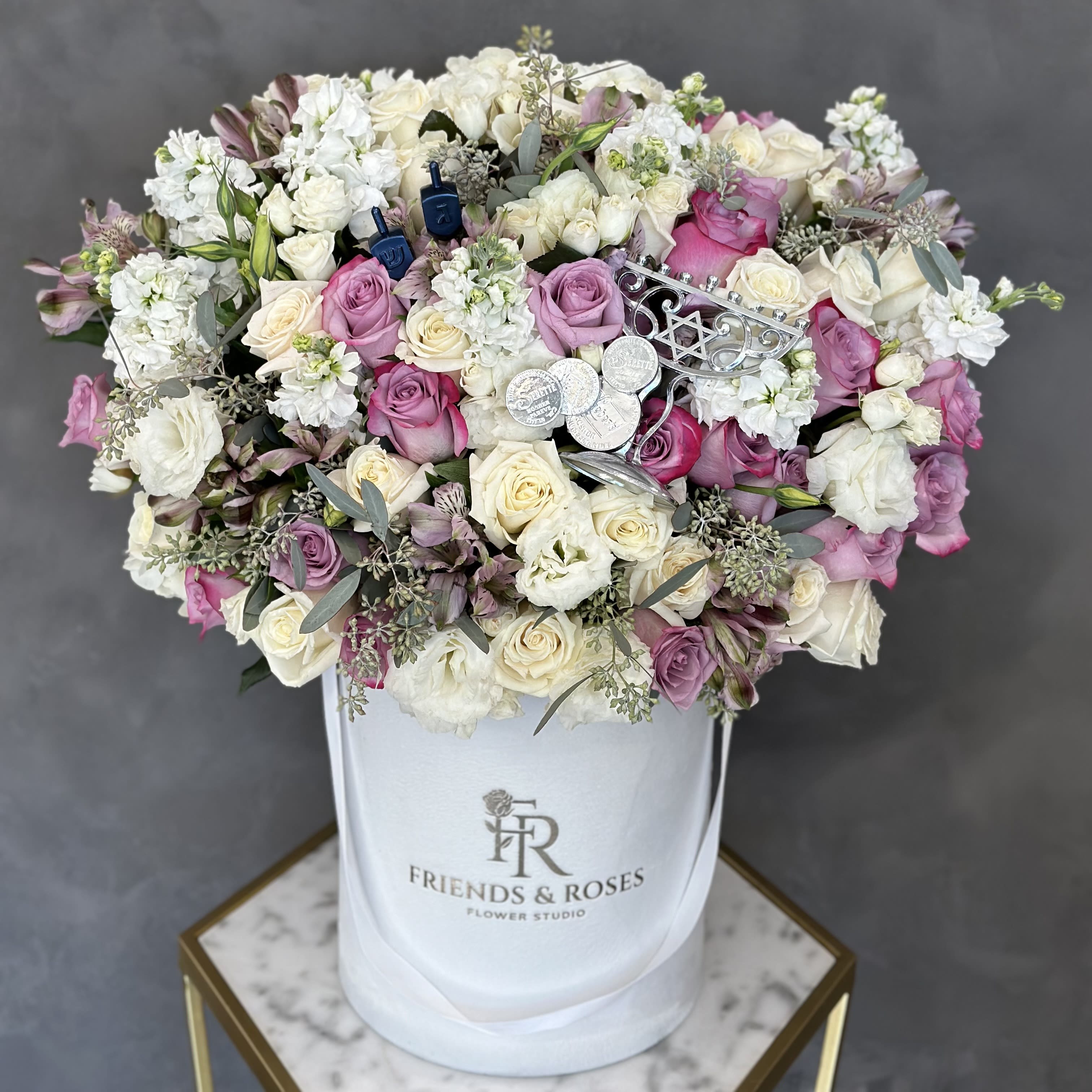 Hanukkah Joy  - Beautiful Hanukkah arrangement in our signature white box, with premium flowers, chocolate coins, a small menorah, and dreidels.