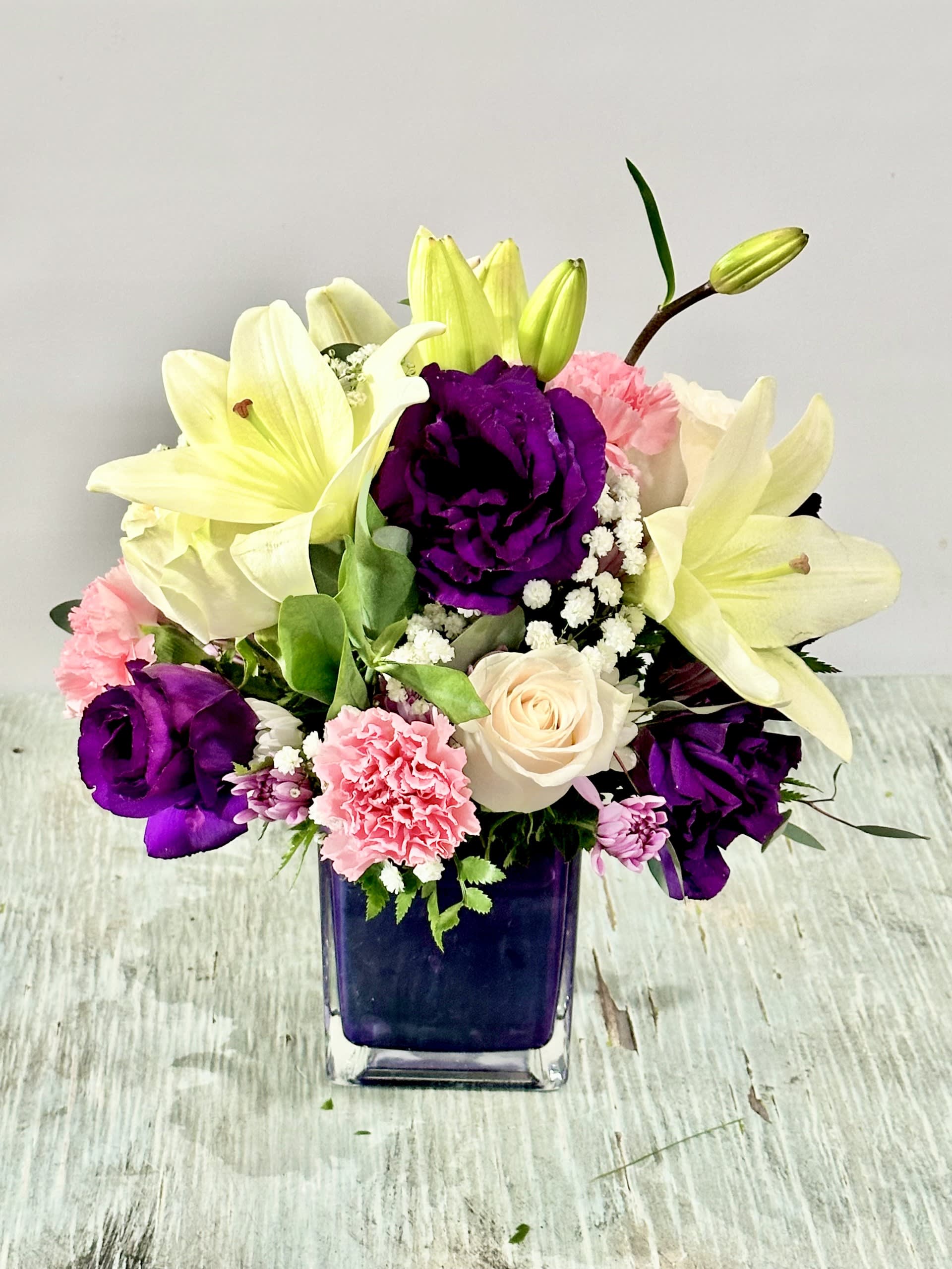 Birthday #9 Birthday #9 - Arrangement of fresh cut flowers in a purple glass cube. Colors can be modified depending on availability.