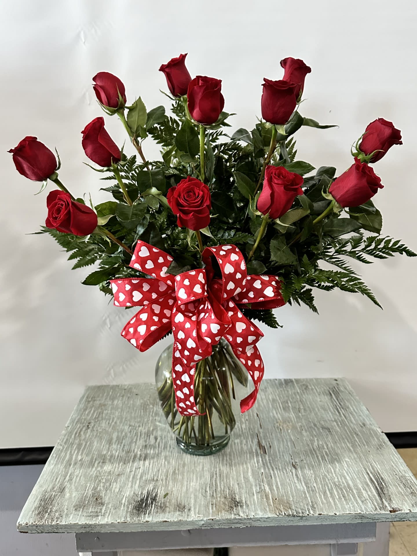Love & Romance #14 Love & Romance #14 - One dozen red roses arranged in a clear glass vase. Color can be modified depending on availability.
