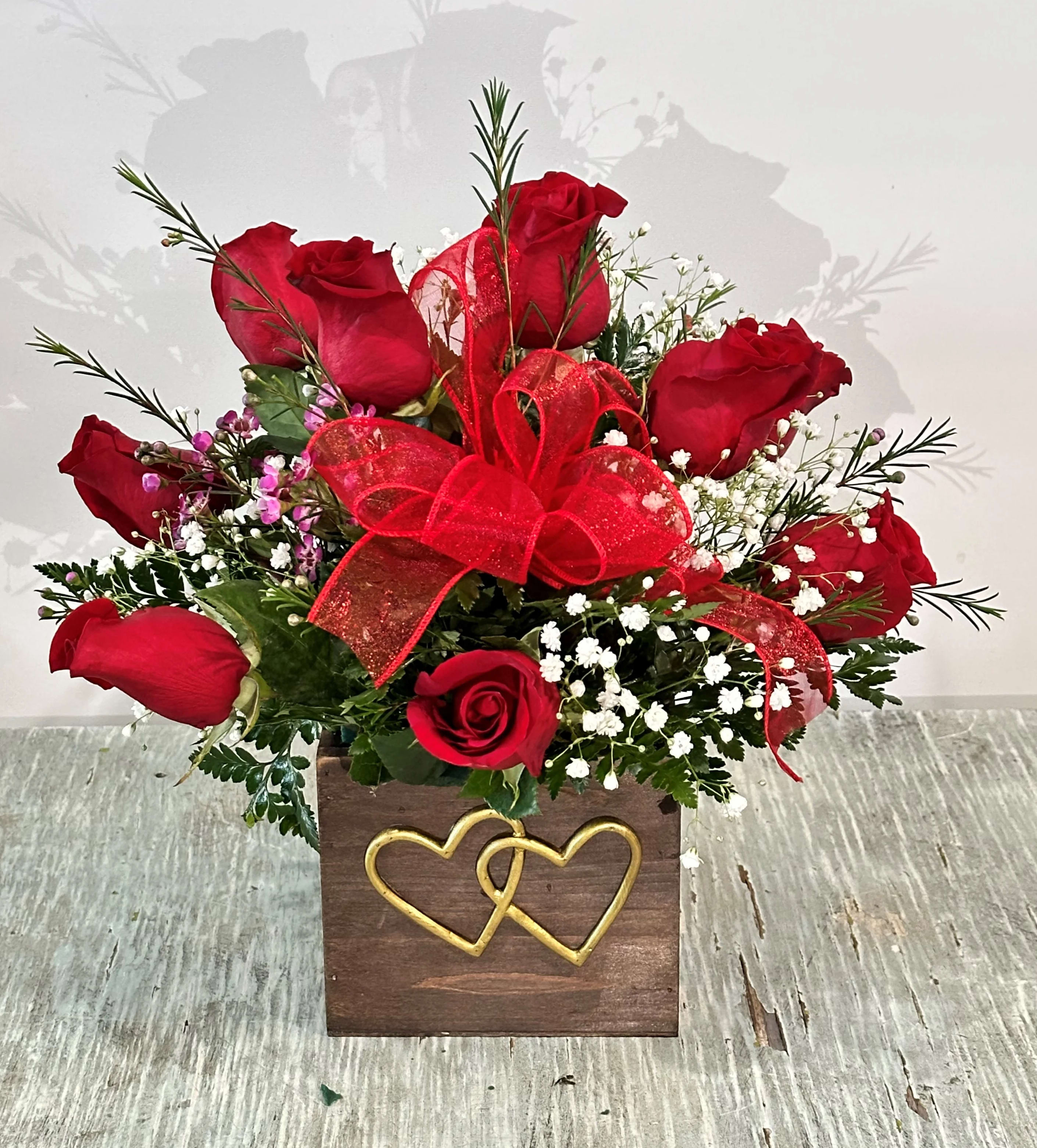 Love & Romance #6 Love & Romance #6 - Arrangement of red roses designed in a wooden box embellished with a raised gold intertwined hearts on the front.