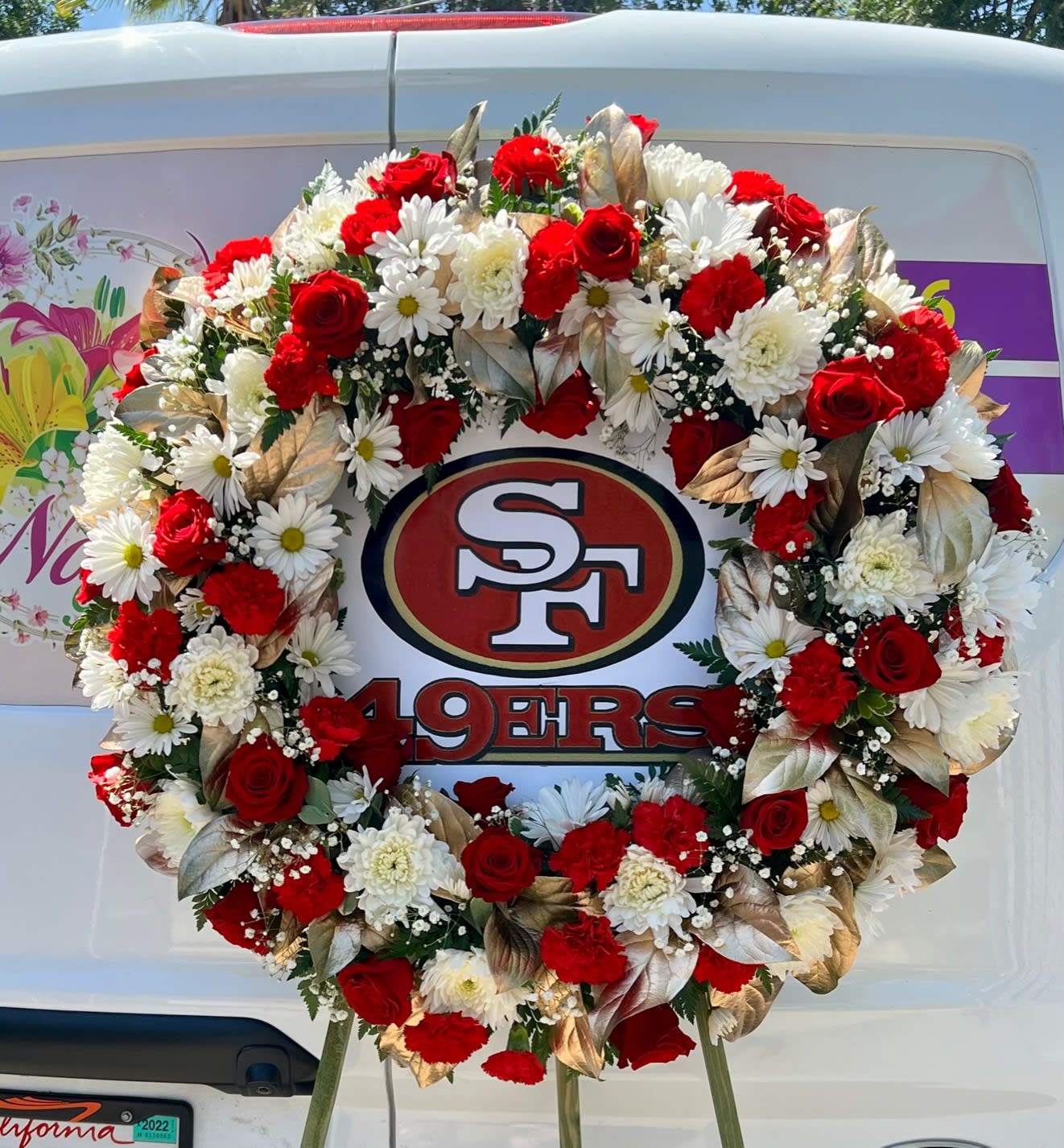 Sympathy Wreath #55 - Sympathy wreath assembled on an easel, that includes football logo. Must be ordered with at least a week in advance.