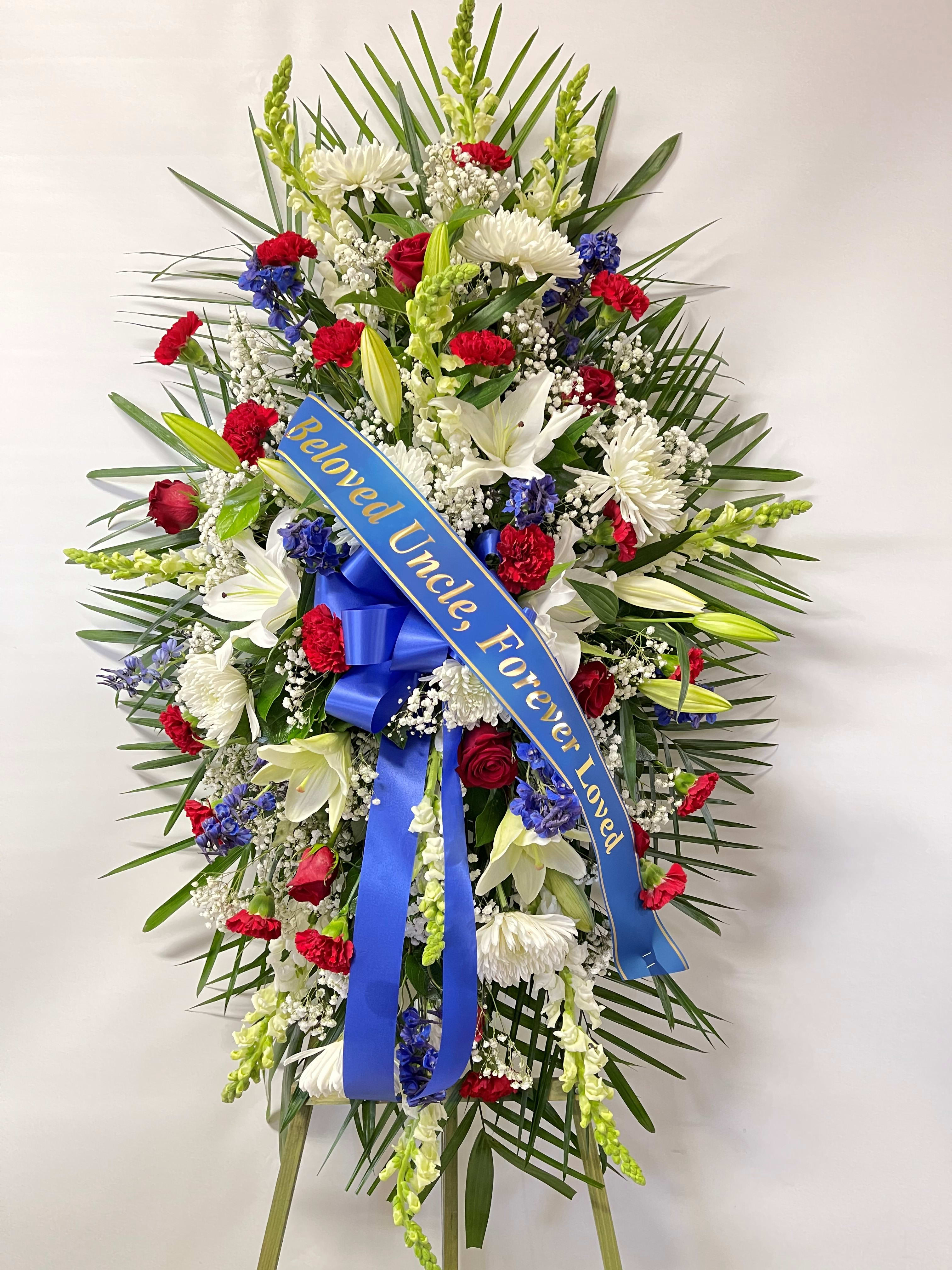 Sympathy Standing Spray #36 Sympathy Standing Spray #36 - Standing spray of red, white and blue fresh cut flowers. Designed on an easel which is included with the arrangement and does NOT need to be returned. Colors can be modified depending on availability. Banner is included with arrangement. Please specify what is to be printed on banner upon check out under "FLORIST INSTRUCTIONS". LIMITED TO 5 WORDS ON BANNER.