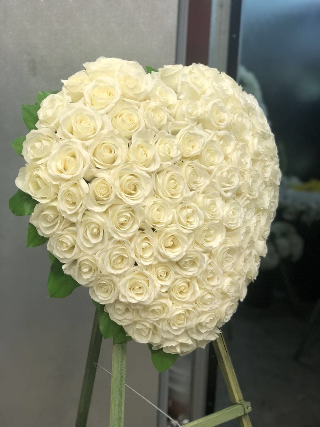 Elegant Remembrance Standing Heart A1 Elegant Remembrance Standing Heart A1 - The Flower Factory Elegant Remembrance Standing Heart is an exquisite display of peace and love. 77 stems of white roses are artfully arranged in the shape of a heart and presented on a wire easel, creating a simply beautiful tribute for their final farewell service. Dimensions:24"x22" Orders must be placed weeks in advance to allow for processing