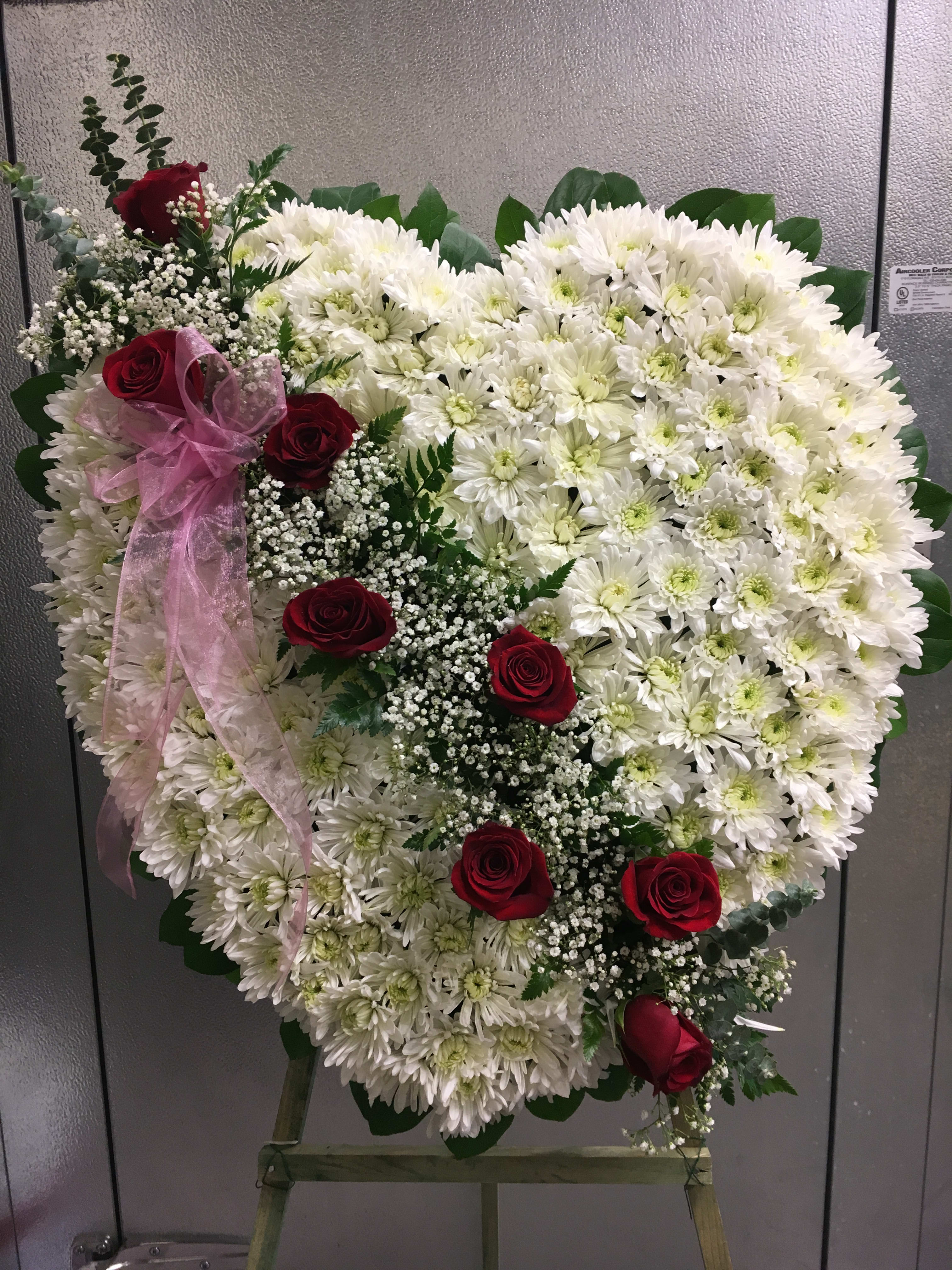 Broken Heart Sympathy Spray (Cushion Pompon) Broken Heart Sympathy Spray (Cushion Pompon) - The modern funeral spray handcrafted by an artisan florist to deliver your condolences is constructed of white cushion pompon and red rose, complemented by lush greens. It makes a superb, time-honored addition when displayed on a wooden easel for a wake or funeral service, graveside at a burial, to decorate a headstone, or to set adrift for burials at sea. Our florists hand-design each arrangement, so colors and assortment may vary based on local availability Orders must be placed three days in advance to allow for processing