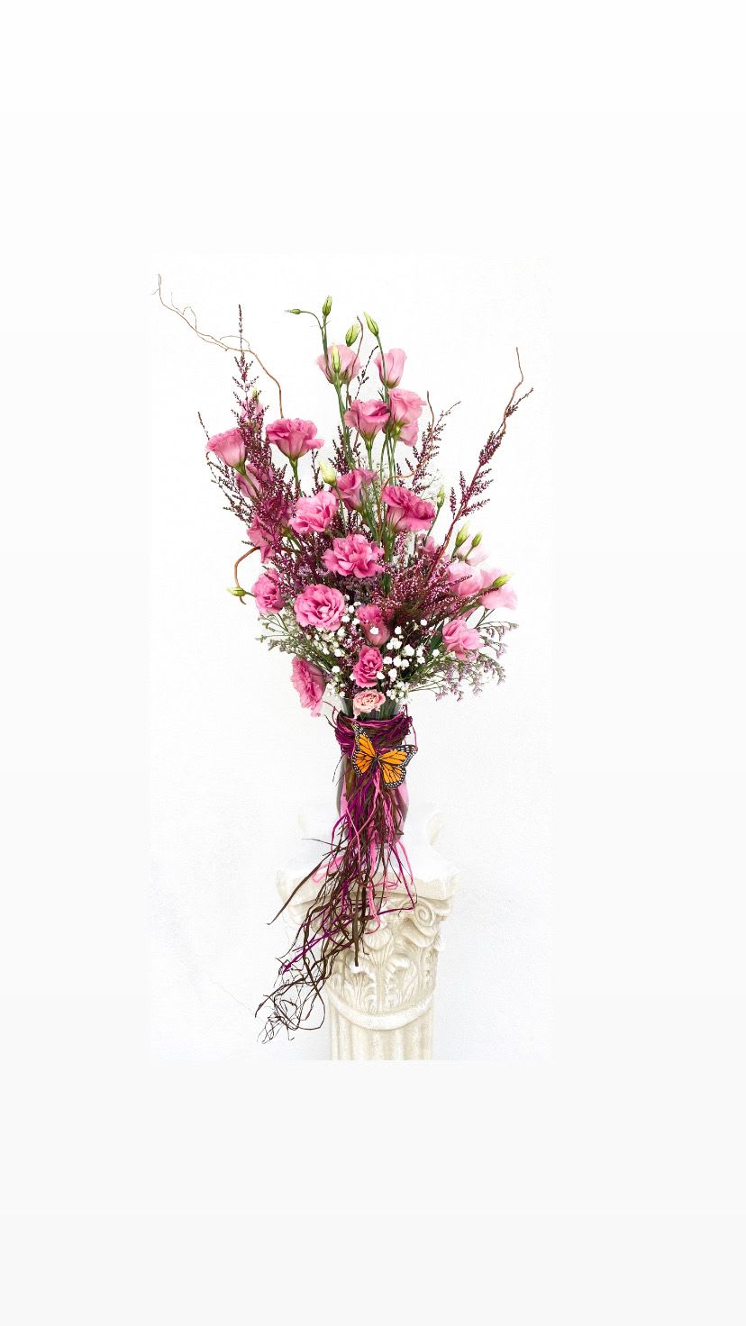 Floral Designer’s Choice - Pink Shades &amp; Butterflies - Put your trust in Sunset Flor to create the most beautiful hand-tied bouquet that showcases fresh, in season florals.   Each bouquet is unique with Pink Shades like shades of pink, purple, red, white, and a decorative Butterfly.  Vase is included along with flower food, a flower info sheet, and a care card.   *Bouquet in photo is an example of Floral Designers Choice - Pink Shades &amp; Butterflies. Not every bouquet is the same but will always have the freshest, in season, high quality blooms.*