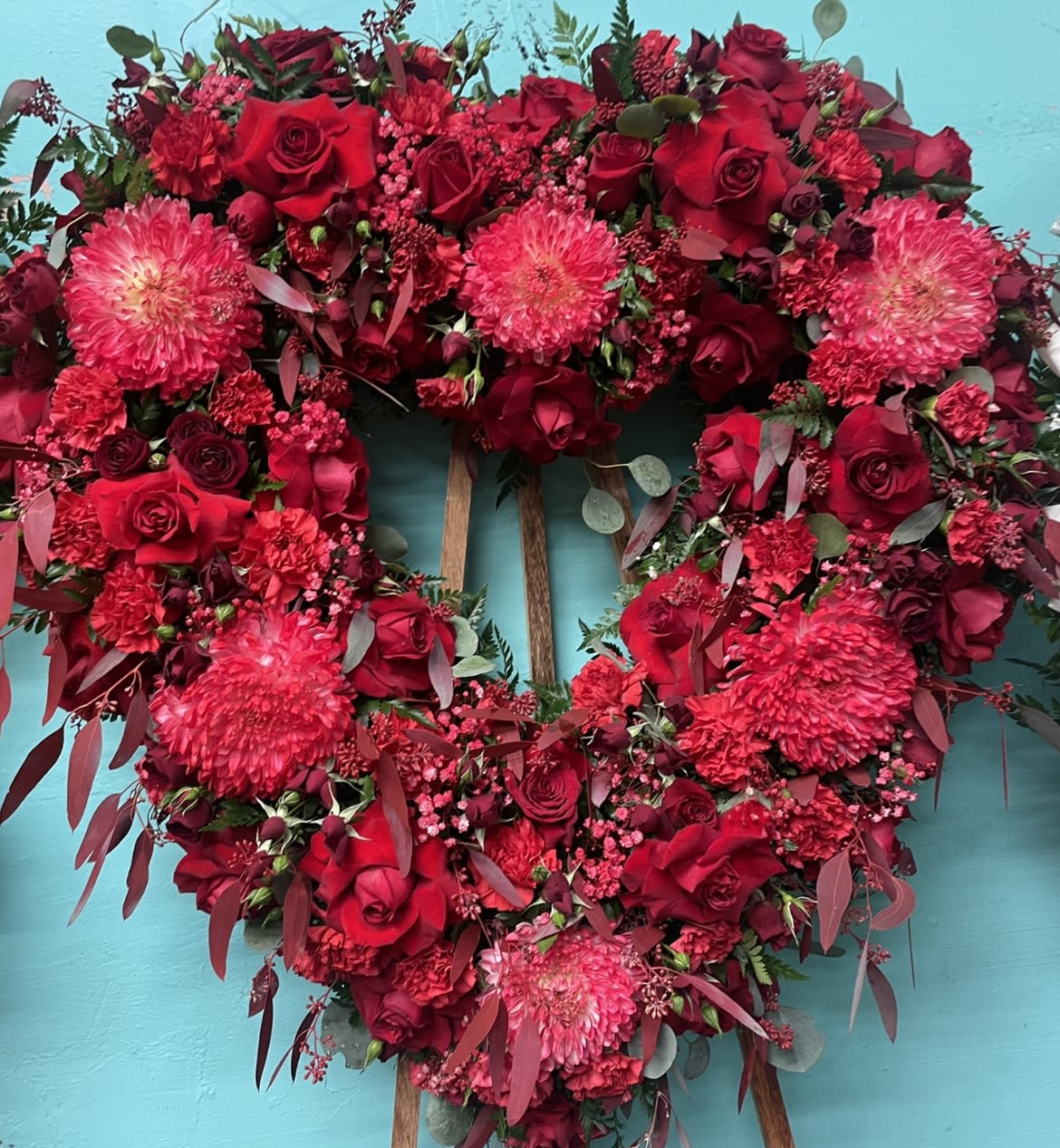 In loving memory In loving memory - We proudly offer you this stunning arrangement that is red mums, roses, and spray roses. We can customize this arrangement if desired.