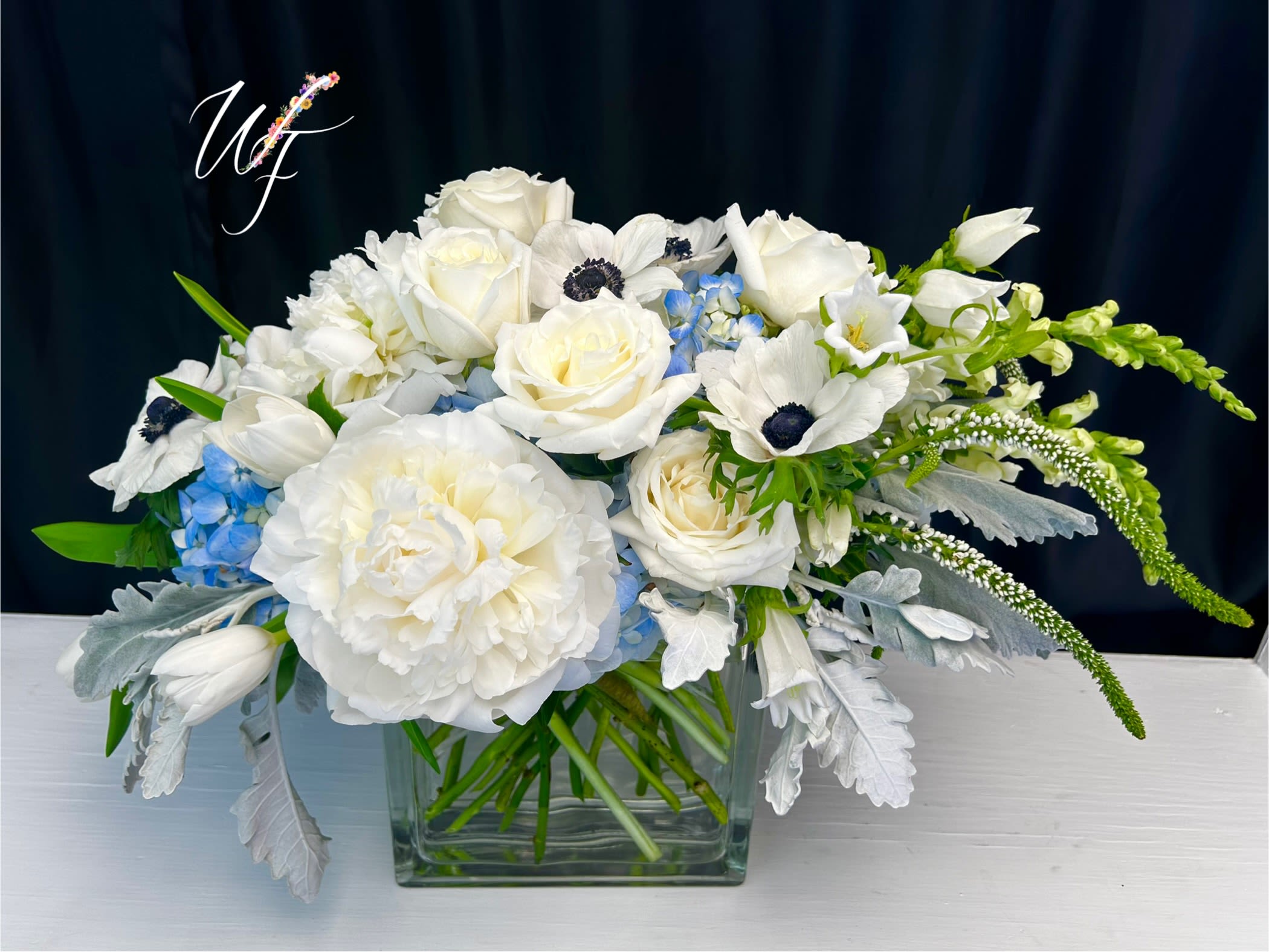 Calm Wave’s - Low contemporary unique design with high end flowers in the shades of the Cape.