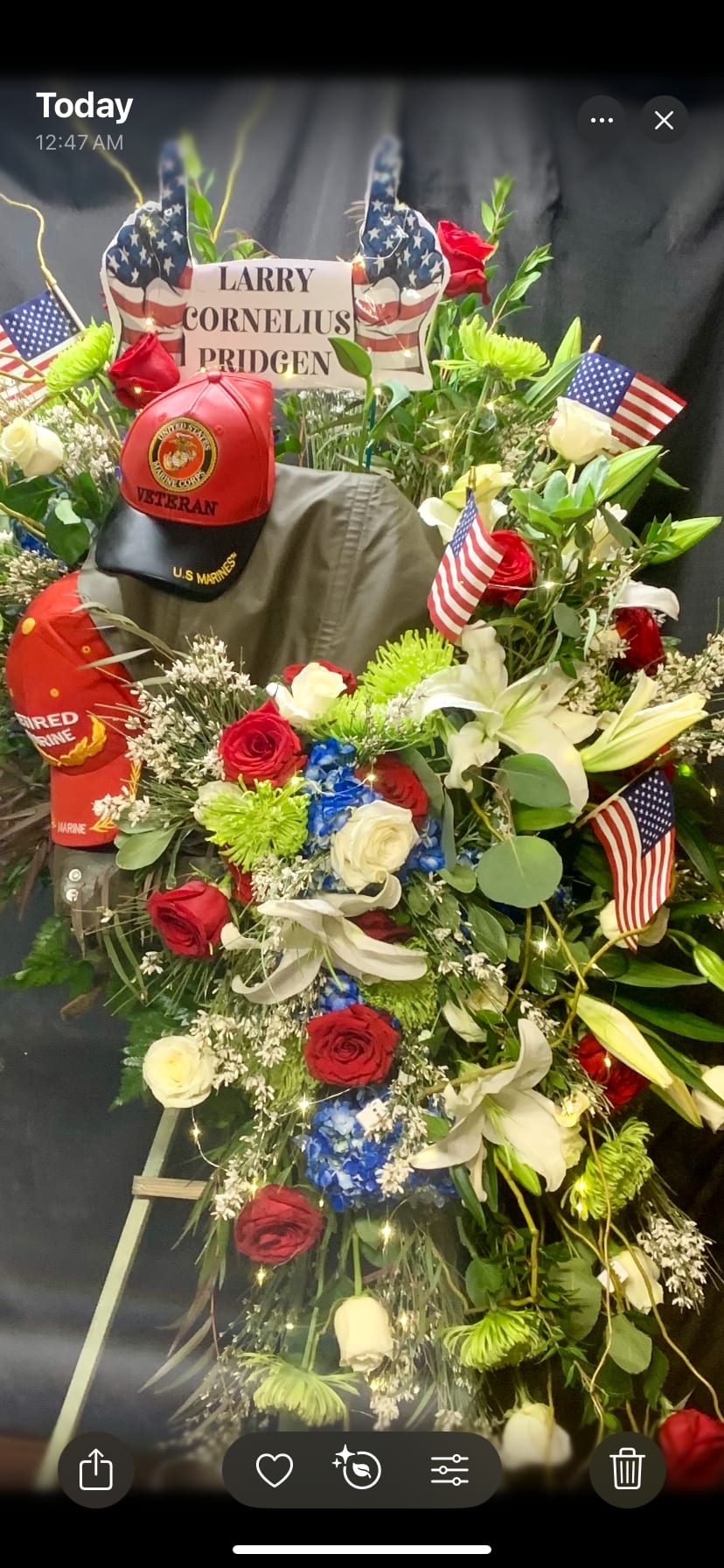 VETERAN MEMORIAL STANDING SPRAY - ALL THE COLORS OF AN HONORED VETERAN WITH PERSONALIZED ITEMS ADDED.