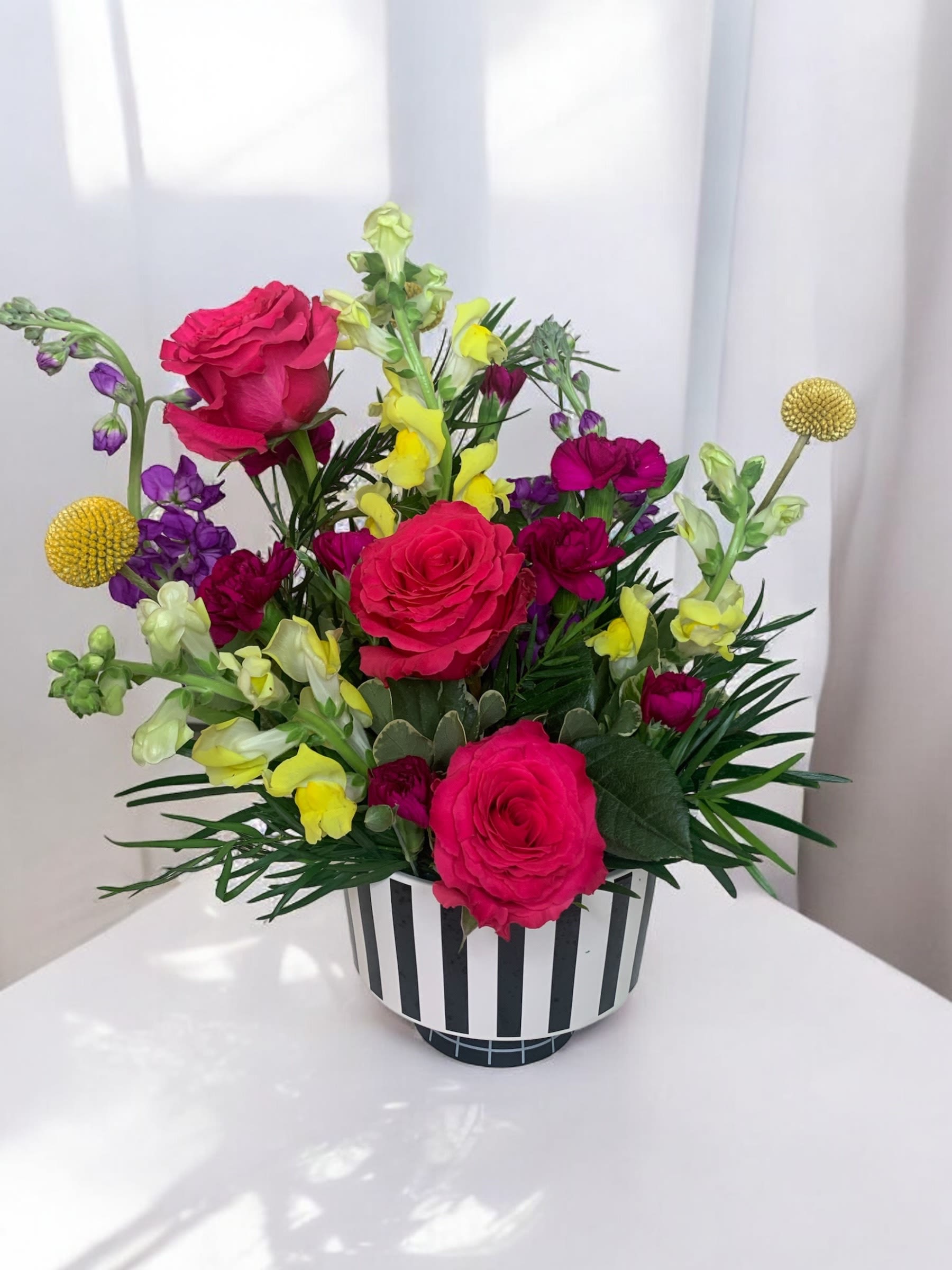 Big Top Surprise - What could bring more joy than the circus? A beautiful flower arrangement reminiscent of a trip to the big top! Beautiful roses, snapdragons and stock in fabulous bright colors make this the best choice to bring loads of cheer!