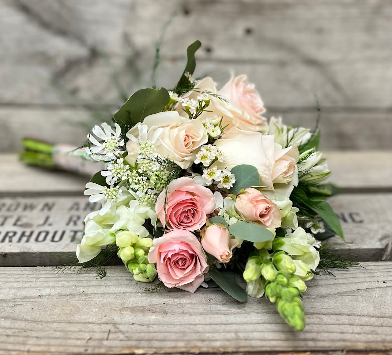 Prom Nosegay - White &amp; Pinks - Mix of all white &amp; pink flowers arranged beautifully in small handheld handpicked look will have a variety of filler and eucalyptus greens. Stems will be wrapped in your choice color sheer ribbon. Ribbon color is to compliment dress color not exactly match. All bouquets will be finished with light glitter.  Please note in special instructions what color ribbon and any other special requests.  Bouquets typically contain a mix of roses, spray roses, alstroemeria, daisies, stock, hydrangea, snap dragons, carnations, mini carnations, fillers and greens    Bouquet will not match the photo exactly, as each nosegay is uniquely hand made by our designer. Will have same look, feel and size.  
