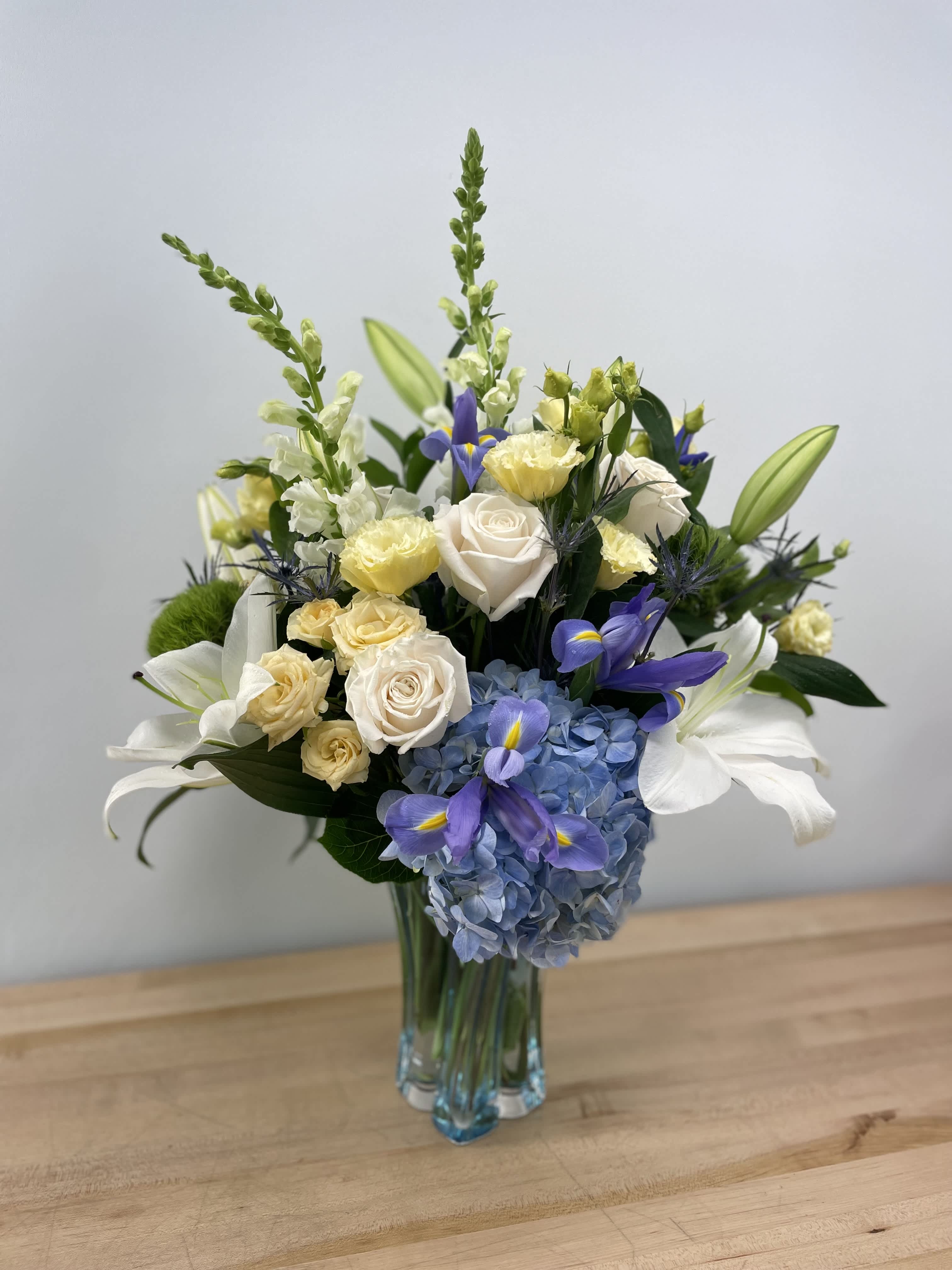 Blooming Fantasy Blooming Fantasy - An arrangement composed of white, yellow and a touch of blue that can be perfect for any special occasion!