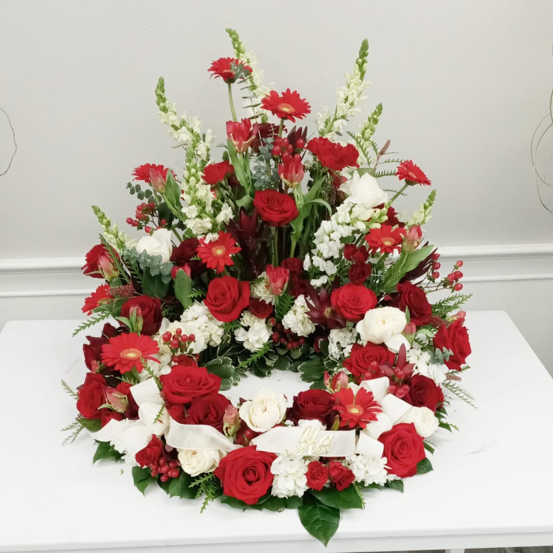 Sympathy Urn Arrangement Red & White $199.99 & Up Sympathy Urn Arrangement Red & White $199.99 & Up - This arrangement surrounds the urn of your loved one with roses, snapdragons and gerbera daisies. Pictured arrangement $249.99 Containers and flowers may vary from pictured arrangement.
