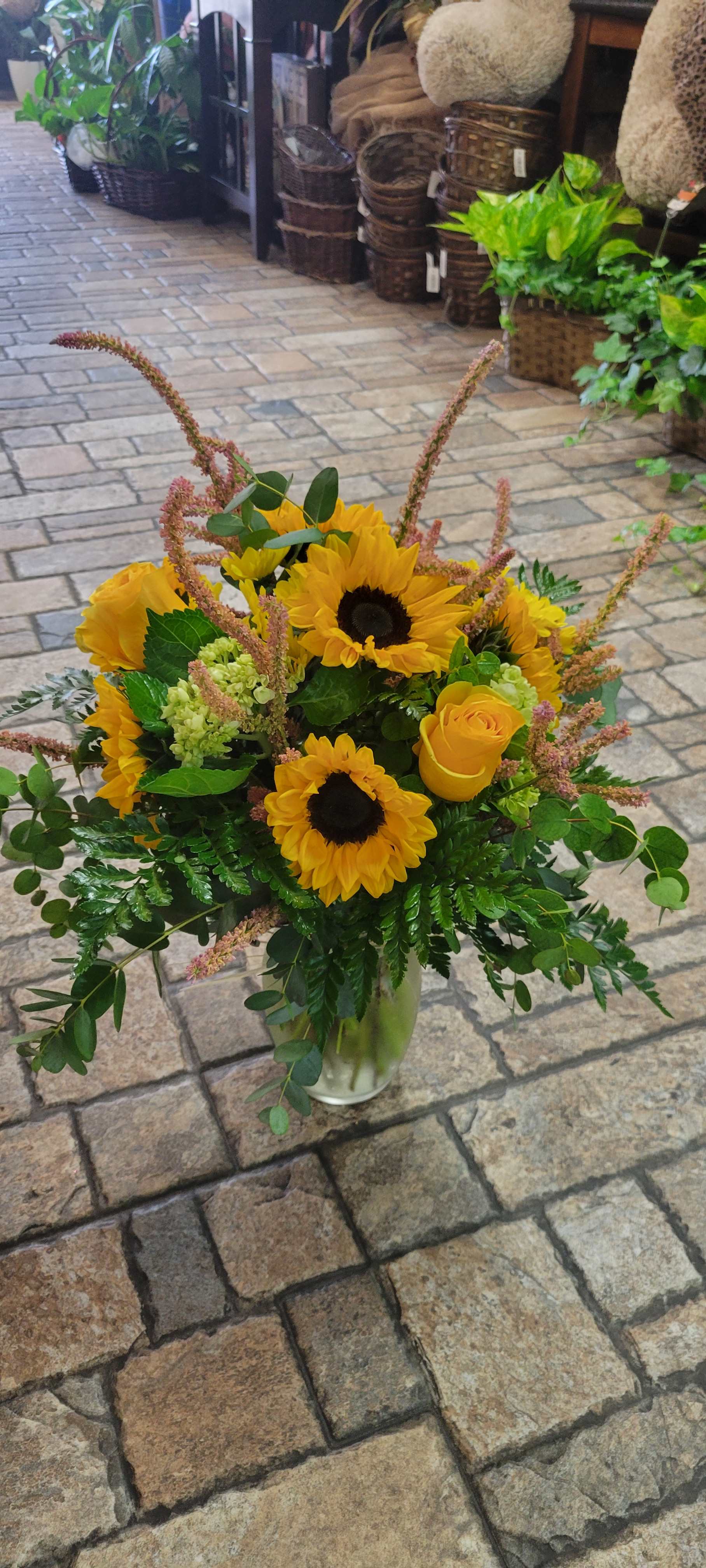 Sunflower Meadows Sunflower Meadows - A fall meadow like arrangement made with stunning sunflowers and natural accents and greenery.