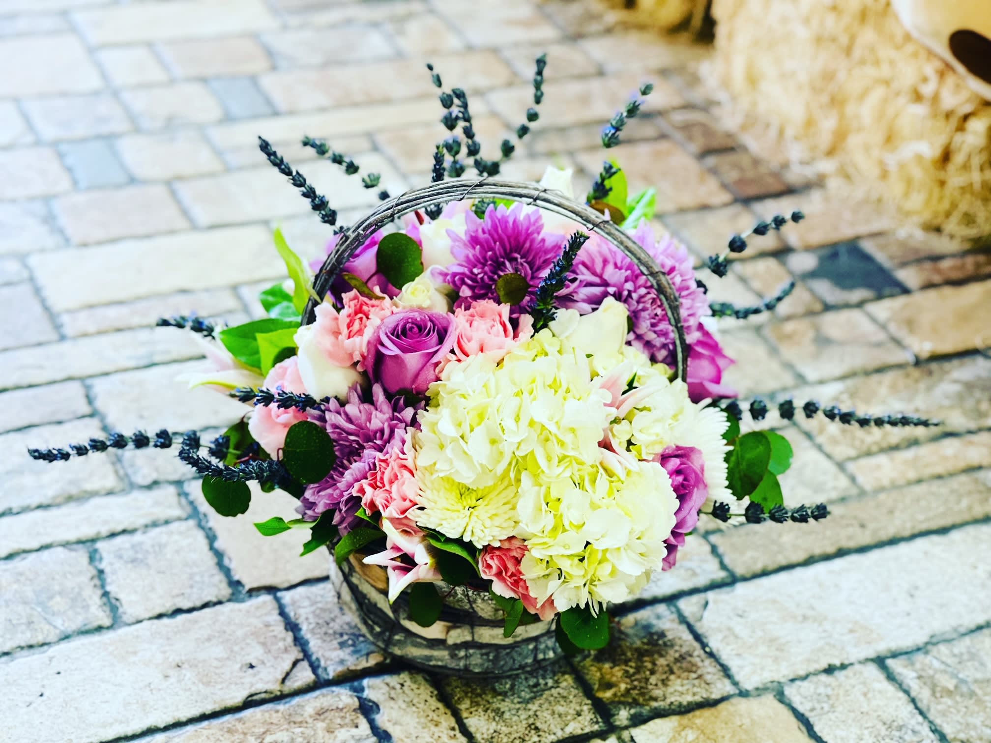 Luxe Lavender Basket Luxe Lavender Basket - FRESH AND AROMATIC LILIES, ROSES, DRY LAVENDER, CARNATIONS, AND HYDRANGEAS IN A NICE BASKET. The container may vary depending on availability. Bouquet may be sent in a basket, a metal or a plastic container.