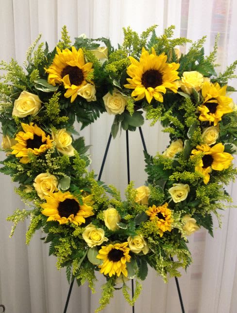 Sunflowers Sympathy Wreath Sunflowers Sympathy Wreath - This beautiful heart is made with sunflowers, yellow roses, solidago, and a variety of green foliage. It will be a loving and lasting tribute to a very special person.