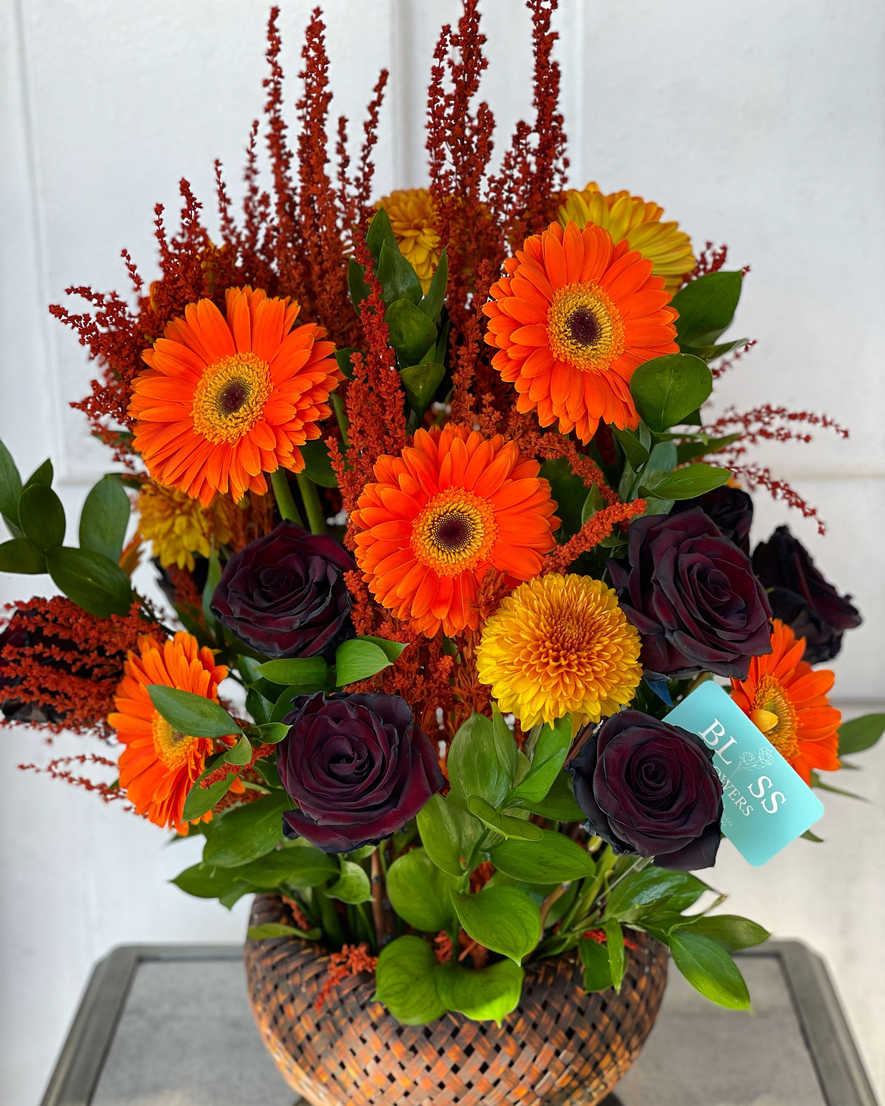 I got sunshine on a cloudy day I got sunshine on a cloudy day - A unique blend of dahlias, black roses, and orange gerbers, that is sure to brighten your summer day. This seasonal arrangement is only available in the summer and fall.