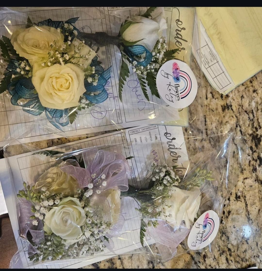 Pearl Wrist Corsage and Boutonniere Combo - Pearl bracelet attached with spray roses, filler, and greens. With your choice of colored ribbon. Magnetic boutonniere that matches upgrading adds extra flowers/bling
