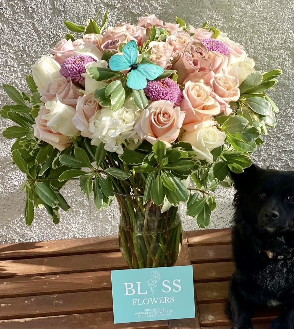 Blissful Bunch Blissful Bunch - Blissful Bunch for Mom! This charming arrangement is a loving tribute featuring soft pink, white and lavender roses. *Sorry, doggy not included*