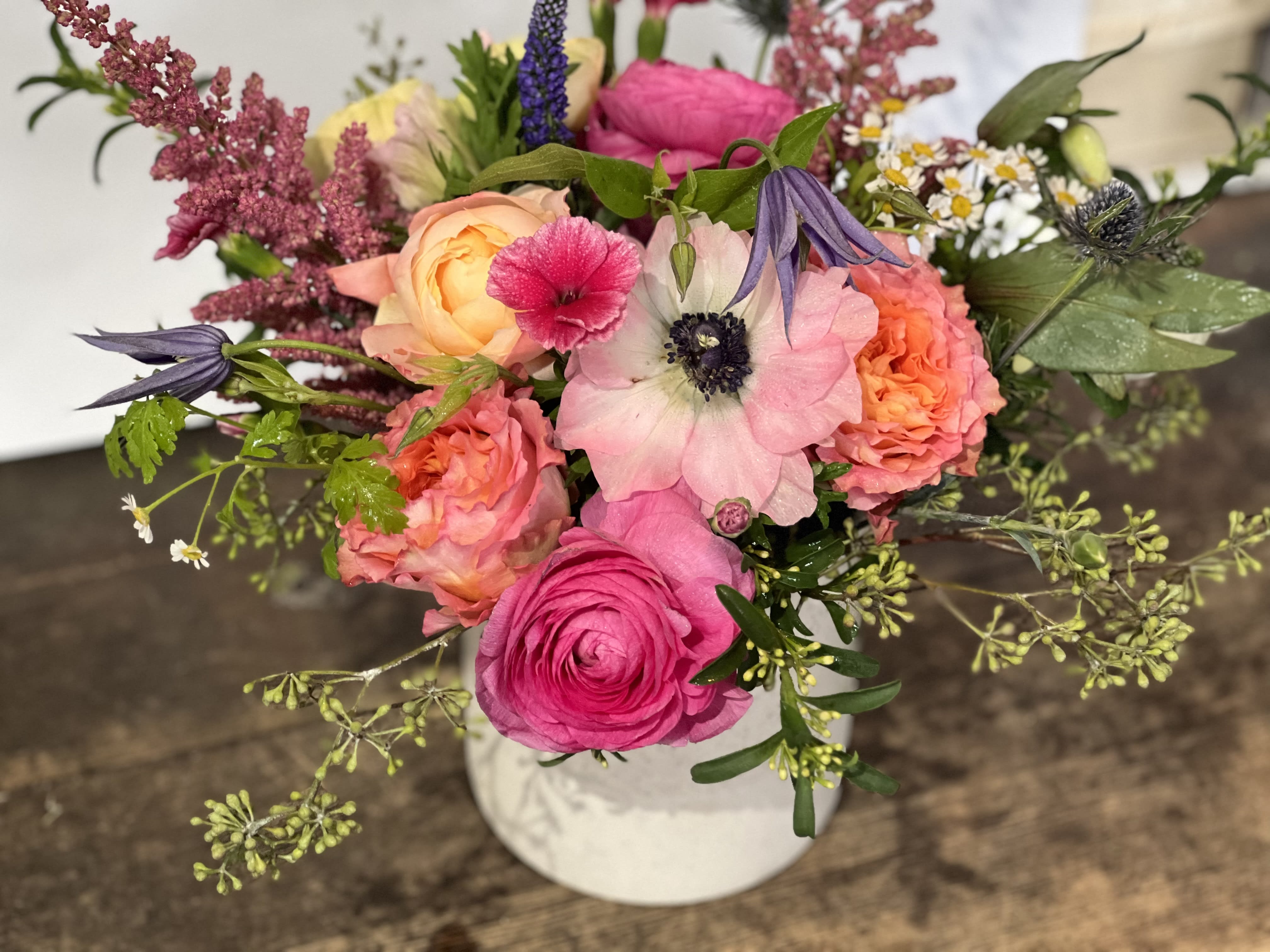 Dreaming of sunsets Dreaming of sunsets - Pink and peach delight. Roses, ranunculus. astilbe, anenome in a simple ceramic vessel