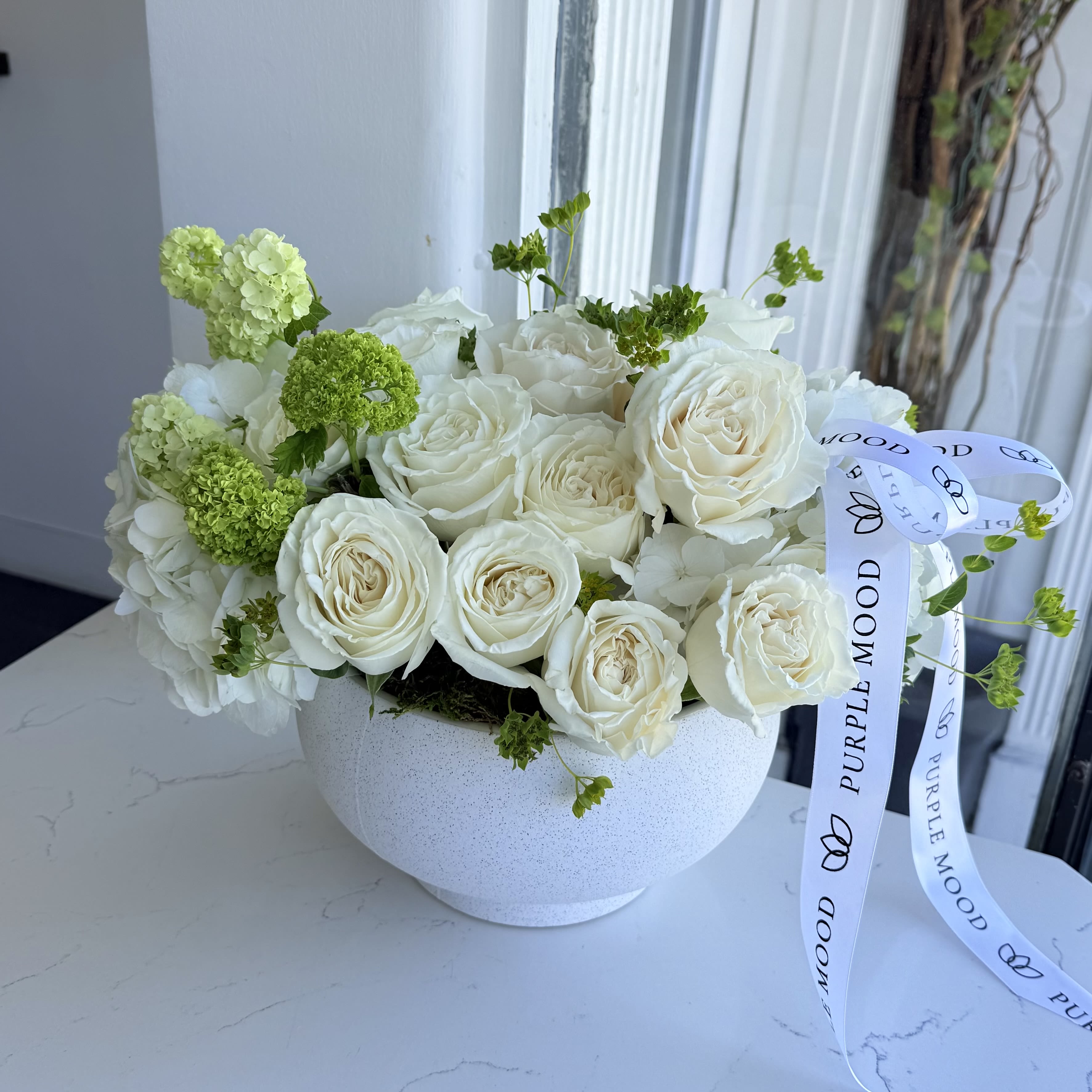White vase White vase - A timeless arrangement of lush white roses, soft hydrangeas, and touches of fresh greenery, all gathered in a modern ceramic vase. Perfect for weddings, anniversaries, sympathy gestures, or simply celebrating pure beauty. Each arrangement is custom-designed and may vary slightly based on seasonal flower availability.