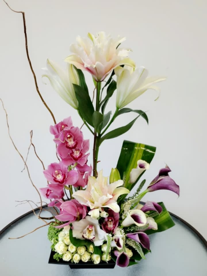 Fantasy and love Fantasy and love - Great flower arrangement consisting of lilies, cymbidium, spray roses, mini calla lilies, veronicas, pitusporum, trachelium and curry willow Request one day in advance Flowers and similar colors