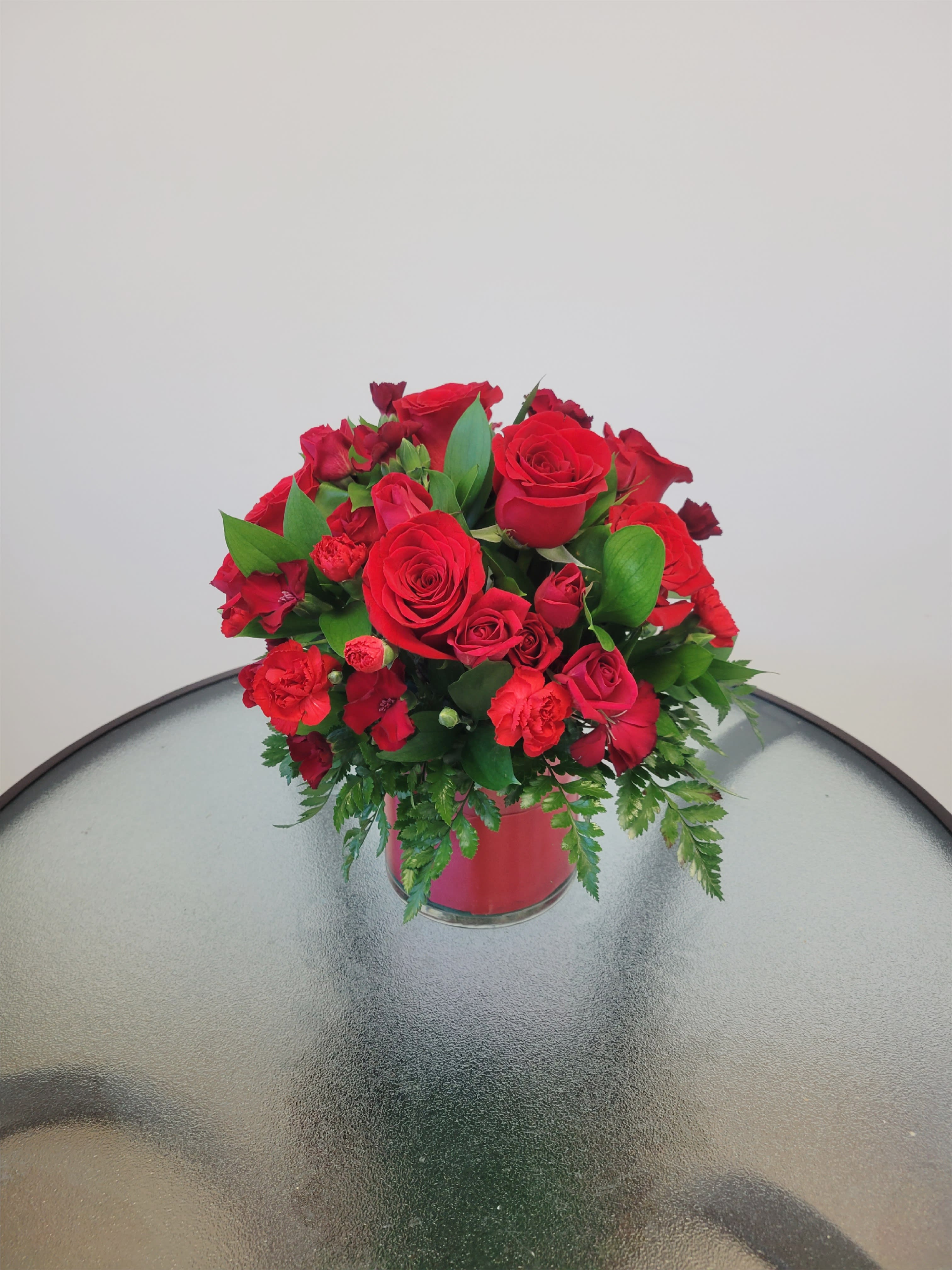 Love is Love  - Red roses means the love you have for someone! Perfect mixed spray red roses and Red roses in a cilinder.  Flowers and similar colors