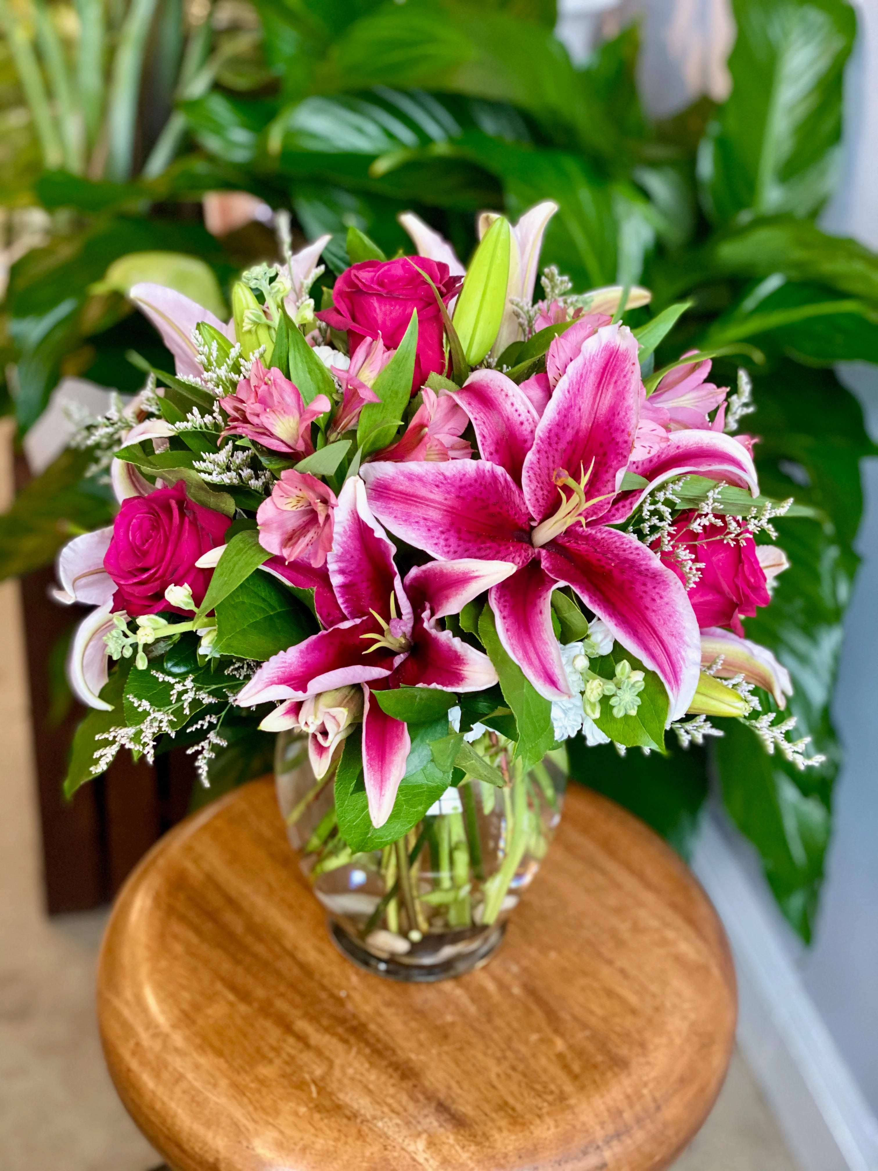 The Norah by Simply Fresh Flowers - The Norah boasts beautiful stargazer oriental lilies, hot pink roses &amp; other seasonal, complementary blooms! Please note: this design is highly scented.