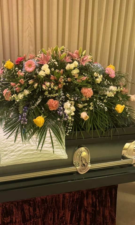 Heavenly Sentiments  - As a tribute to a special person who has passed, this magnificent cascade of pink, white, and yellow floral favorites is a radiant testament of profound and lasting love.