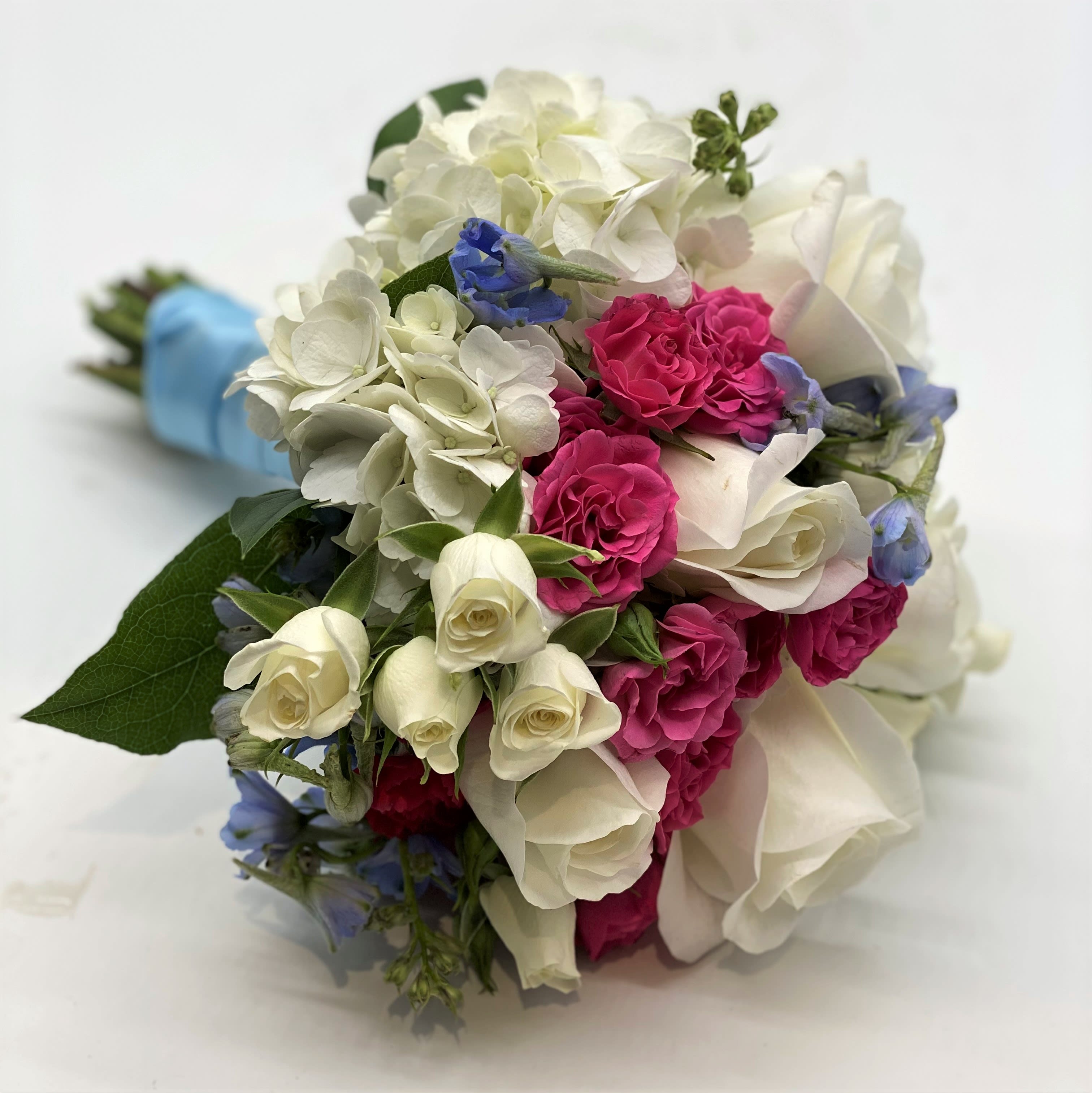The Dream Date Clutch Bouquet - A mix of mostly white flowers with pops of hot pink and light blue!