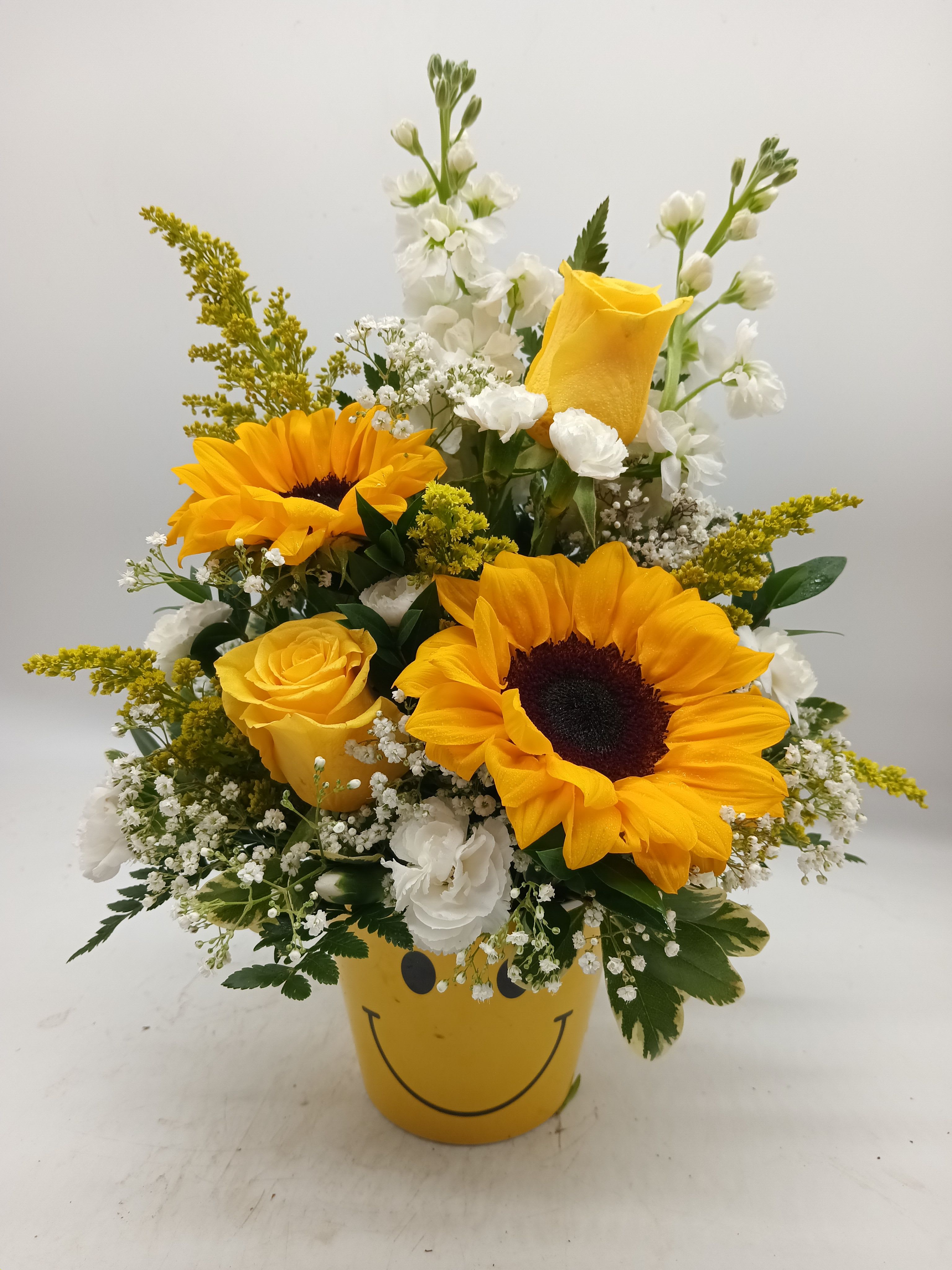 Miles of Smiles - A cheery mix of bright, colorful flowers in a Smiley Container! Just the floral arrangement to put a smile on someone's face!