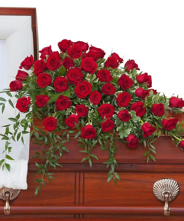 SIMPLY ROSES SUPREME CASKET SPRAY SIMPLY ROSES SUPREME CASKET SPRAY - An abundance of Red roses with premium foliage in a casket spray.