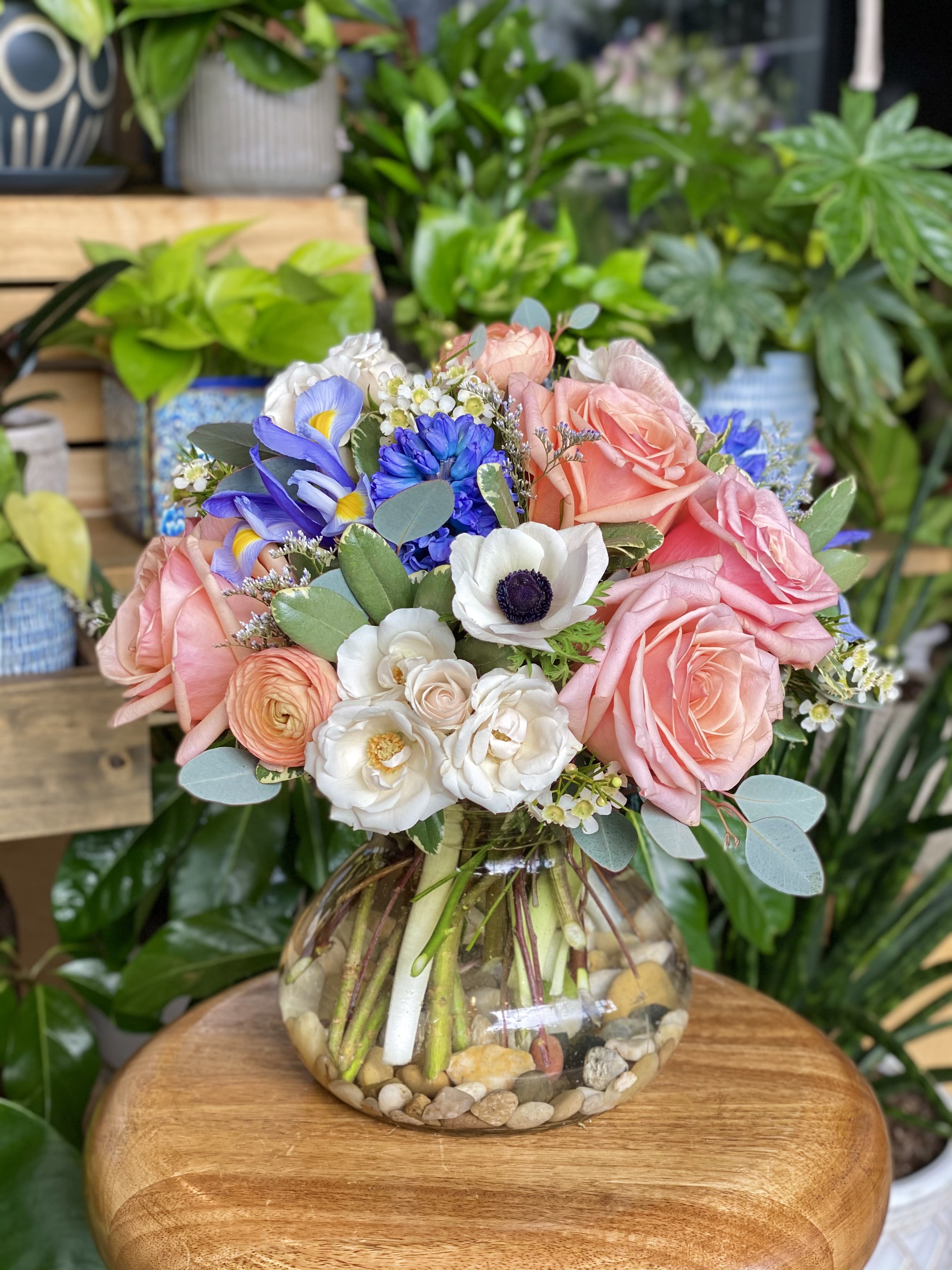 The Ava by Simply Fresh Flowers - The Ava is a gorgeous design of premium Ecuadorian peach roses, salmon ranunculus, white majolica spray roses, California blush anemone, Dutch iris &amp; hyacinth, Australian waxflower &amp; other seasonal blooms. An all sided design that is simply perfect for the lover of fine blooms!