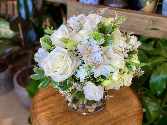 The Diana by Simply Fresh Flowers - The Diana is an elegant green &amp; white all sided design, including hydrangea &amp; Ecuadorian white roses amidst an array of seasonal white blooms &amp; greens. Simply beautiful!