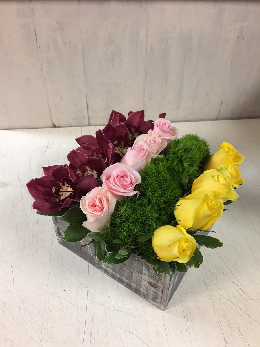 I Got Your Favorites in a Row - An arrangement of roses, cymbidium orchids, and green dianthus in a box
