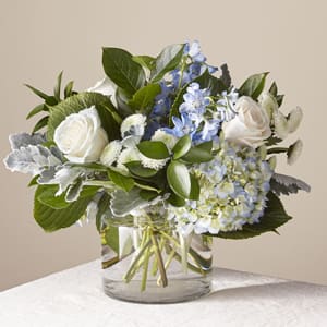 Clear Skies - A glistening clear vase will be filled with our freshest blooms in blue and white.  Vase style and floral content may vary slightly. 