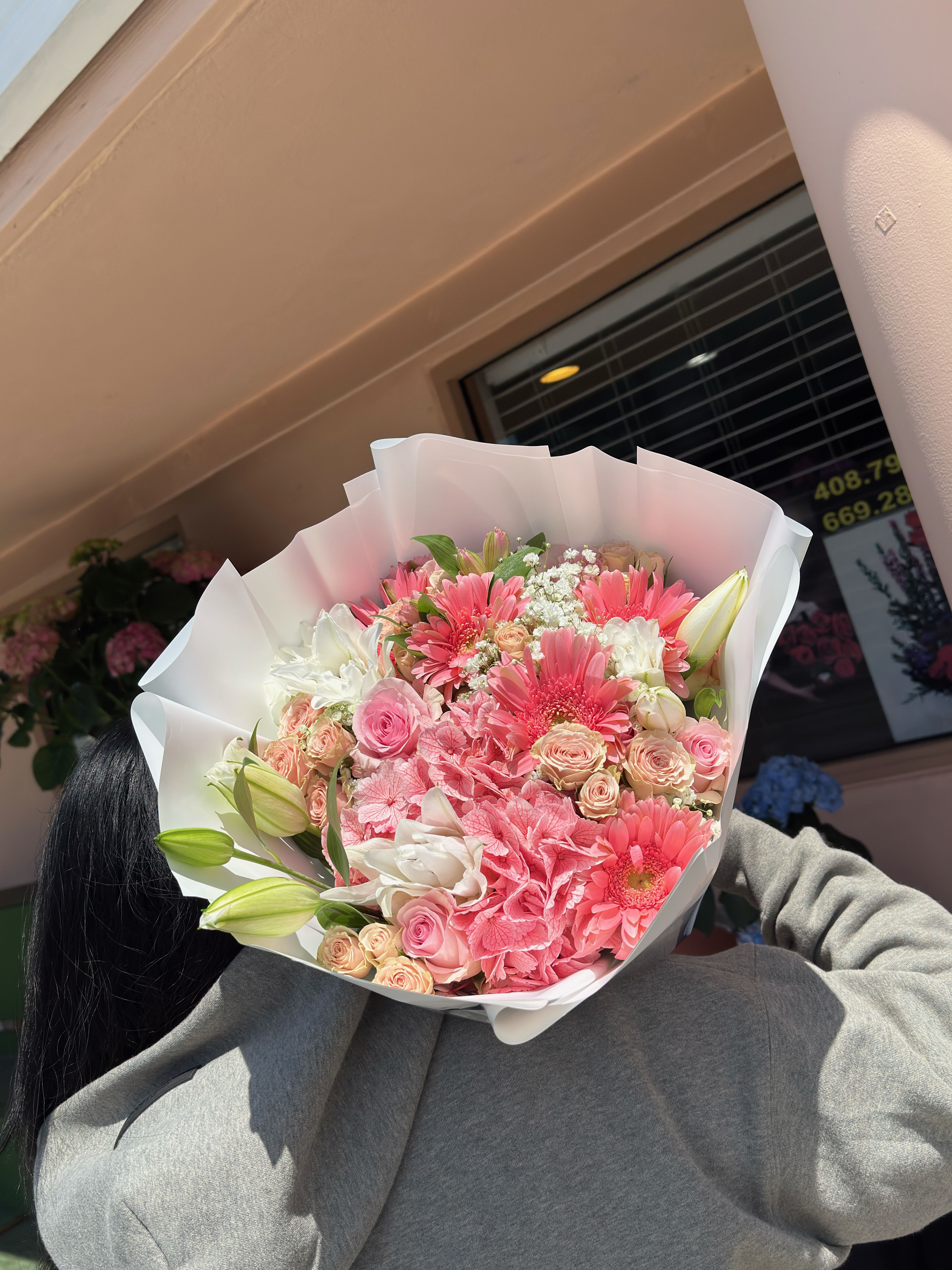 Pretty in Pink - Soft, sweet, and stunning — this pastel bouquet overflows with delicate pink gerberas, roses, lilies, and hydrangeas. Wrapped in sleek white paper, it’s the perfect gift for someone who lights up your world in every shade of pink.