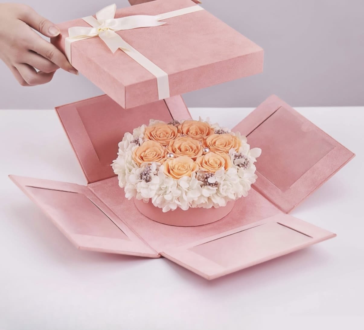 Peach everlasting rose box  - Preserved peach colored roses elegantly displayed in a pink suede box . These are real roses that have been preserved to last for over a year! They make the perfect gift! 