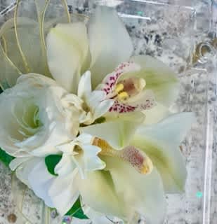 Orchid & Mixed Florals Corsage Orchid & Mixed Florals Corsage - This orchid corsage gem accent will catch the light and compliment any dress. Specify dress color for ribbon or accent floral embellishments. Perfect for prom!