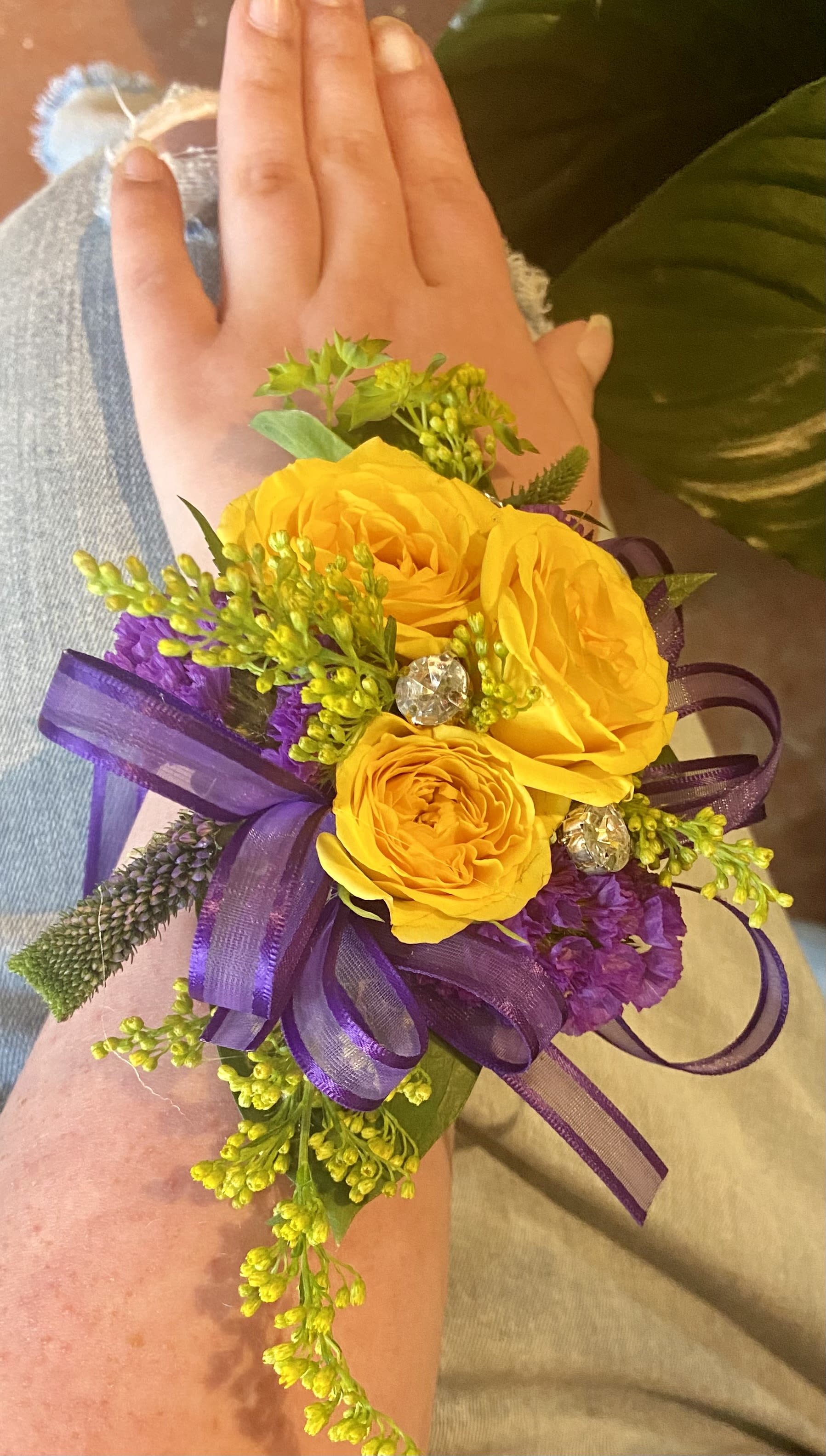 Wrist corsage  - Yellow roses , purple ribbon , greens rhinestones 
