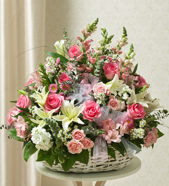 Pink and White Sympathy Basket Pink and White Sympathy Basket - Product ID: 91235 Express all the sympathy and compassion you feel during this time of sorrow with our pink and white sympathy basket arrangement. Exquisitely crafted by our expert florists, the pink blooms represent gratitude and admiration, while the white blooms signify purity and peace. Itâs a tasteful, beautiful way to offer comfort and care to a family member, friend or colleague. Basket arrangement of fresh pink roses and spray roses, white hybrid lilies and more, designed by our select florists in an elegant white washed basket accented with tulle Appropriate for family, friends or business associates to send directly to the funeral home or to the family's home Our florists use only the freshest flowers available, so colors and varieties may vary Measures approximately 28âH x 24âL