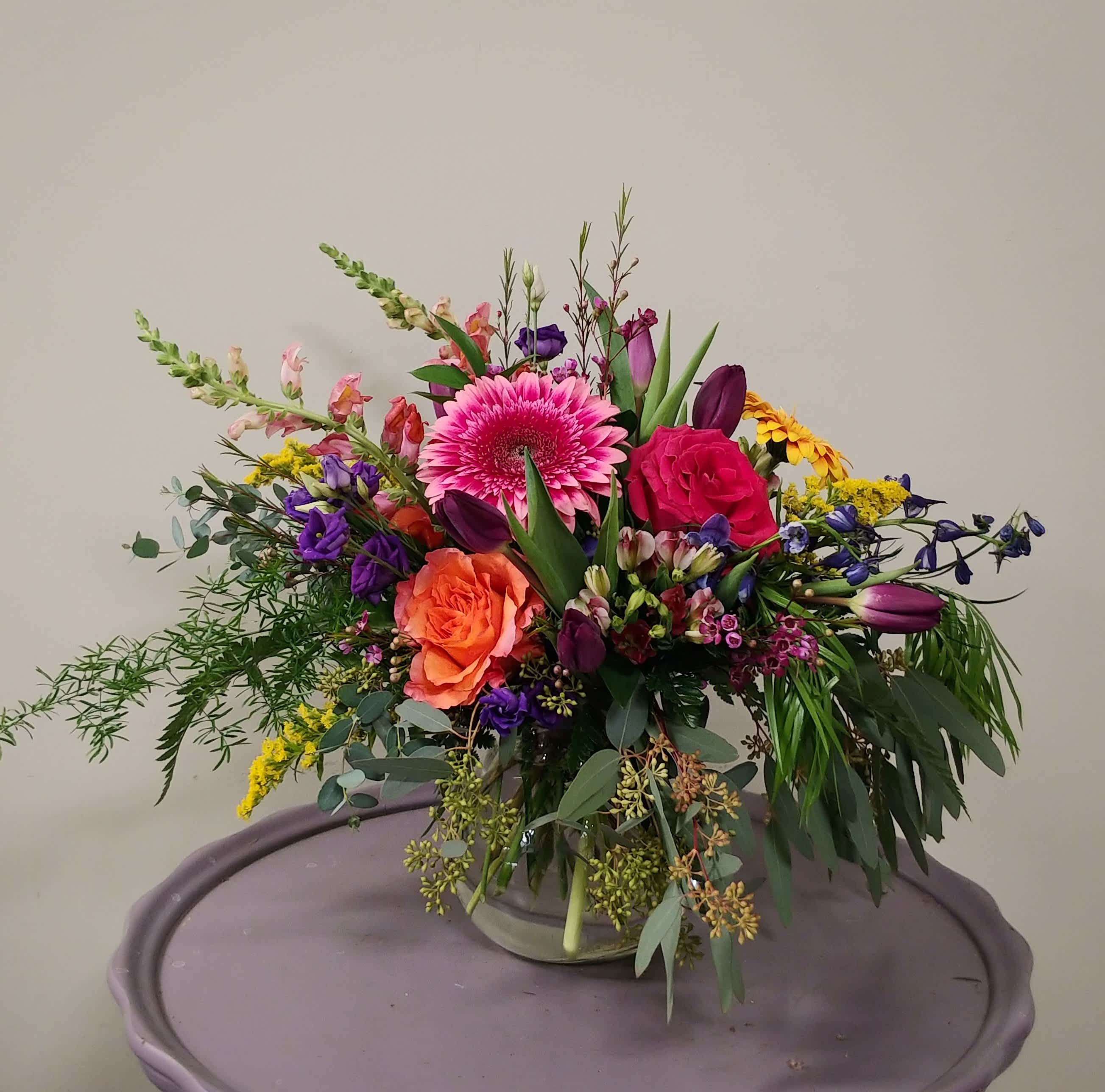 Happy Day - Vibrant roses, bright gerbera daisies and spring flowers! Guaranteed to bring smiles.  Please Note: Each design is custom made and filled to value. We only use fresh product to ensure top quality so new orders are subject to substitutions.