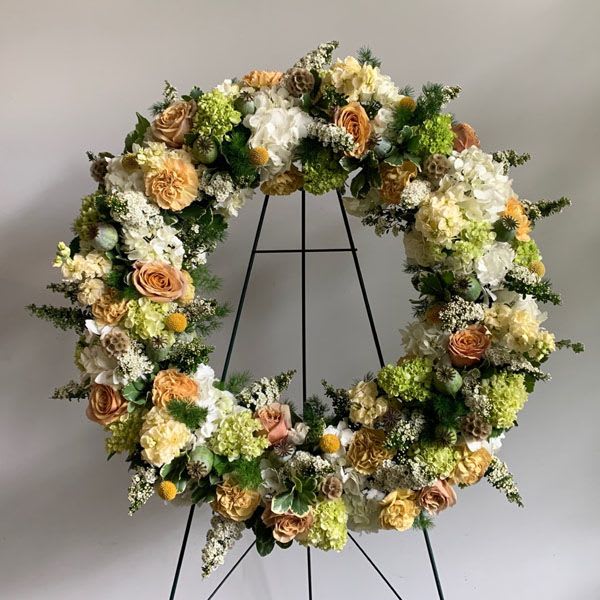 Tribute Wreath - A beautiful mix of seasonal flowers in a soft yet striking palette.  