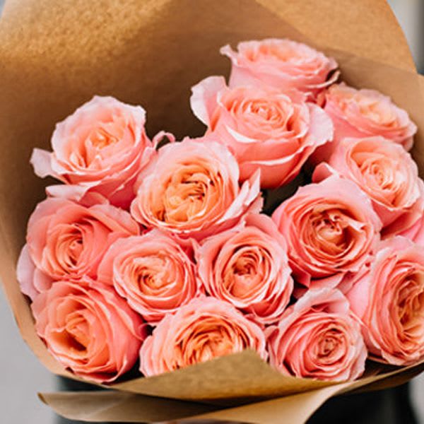 Handcrafted Bouquet of Roses - Bright & Bold Handcrafted Bouquet of Roses - Bright & Bold - 12 beautiful roses are artfully arranged in this handcrafted bouquet and wrapped with tissue, kraft paper and tied with a coordinating ribbon. Our designers will choose the best roses available in a bright and bold color palette. Standard - 1 dozen roses Deluxe - 18 roses Premium - 2 dozen roses PLEASE NOTE: THIS SELECTION COMES WITHOUT A VASE