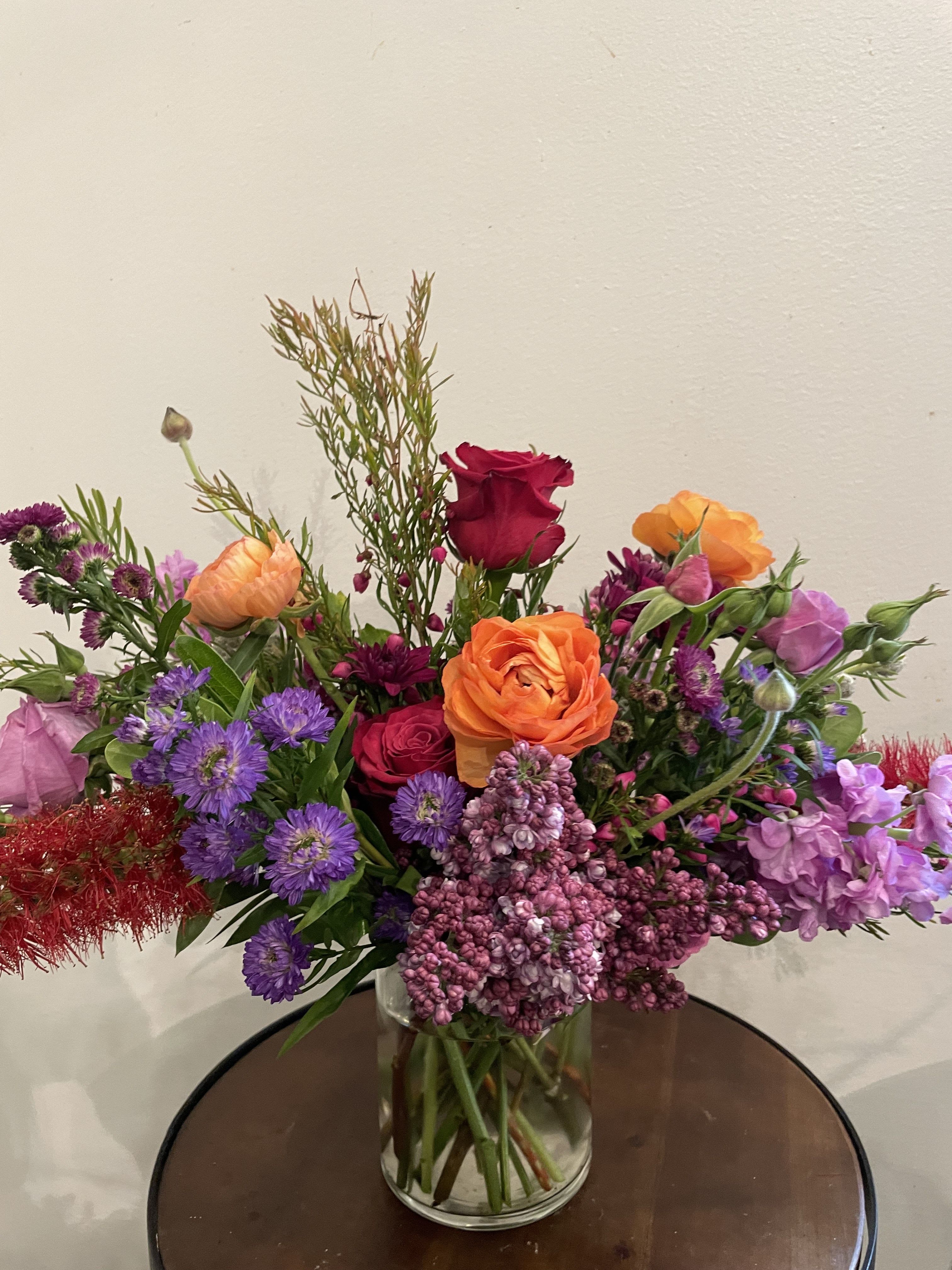 Designer's Choice - Bright & Bold Designer's Choice - Bright & Bold - Sometimes bright and bold is just what is needed. Let us choose a bright and beautiful mix of seasonal blooms to show just how much you care. PLEASE NOTE: Flower colors and varieties will vary due to availability. Our designers always select the freshest blooms for your arrangement. Standard - 4" cylinder vase with a lush mix of seasonal blooms. Measures approximately 7"-8" tall and 7" wide. Deluxe - 5" cylinder vase with a lush mix of seasonal blooms. Measures approximately 10" tall and 10" wide. Premium - 6" cylinder vase with a lush mix of seasonal blooms. Measures approximately 12" tall and 12" wide