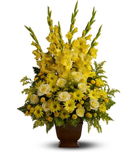Teleflora's Sunny Memories Teleflora's Sunny Memories - Honor a bright spirit who was like a ray of sunshine to everyone they encountered with a grand display of bold yellow blossoms. At almost three feet tall it will add a touch of brightness to any tribute. A mix of fresh yellow flowers such as roses gladioli and chrysanthemums ? accented with fern ? is delivered in a Teleflora Noble Heritage urn. Approximately 19" (W) x 35" (H) Orientation: All-Around As Shown : TFWEB544